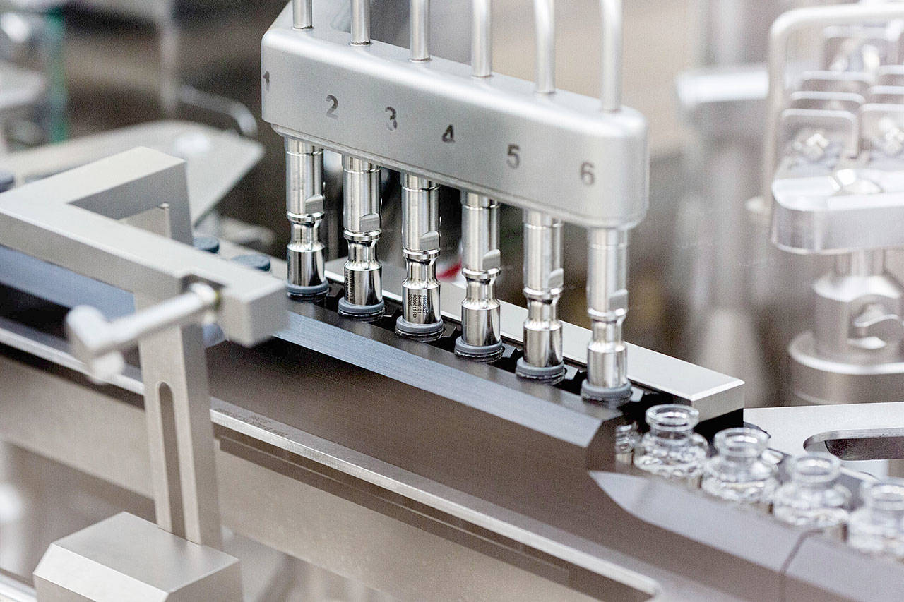 In this March 2020 photo provided by Gilead Sciences, rubber stoppers are placed onto filled vials of the investigational drug remdesivir at a Gilead manufacturing site in the United States. Given through an IV, the medication is designed to interfere with an enzyme that reproduces viral genetic material. (Gilead Sciences via The Associated Press)