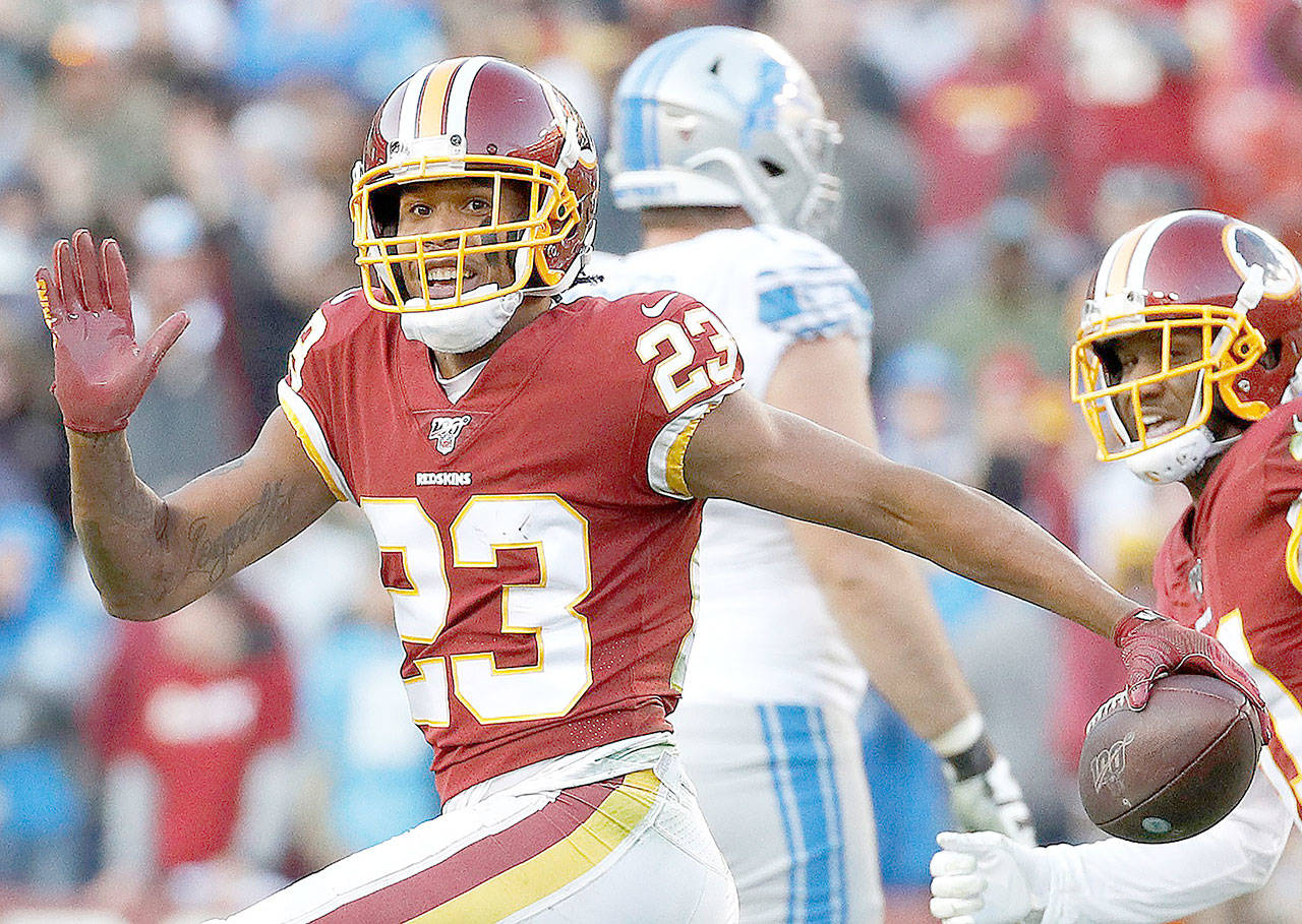 Washington cornerback Quinton Dunbar reacts after intercepting a pass from Detroit Lions quarterback Jeff Driskel during a game in Landover, Md., in November 2019. Police in south Florida are questioning New York Giants cornerback DeAndre Baker and Dunbar, now with the Seattle Seahawks, after multiple witnesses accused the pair of an armed robbery at a party. (Patrick Semansky/The Associated Press)