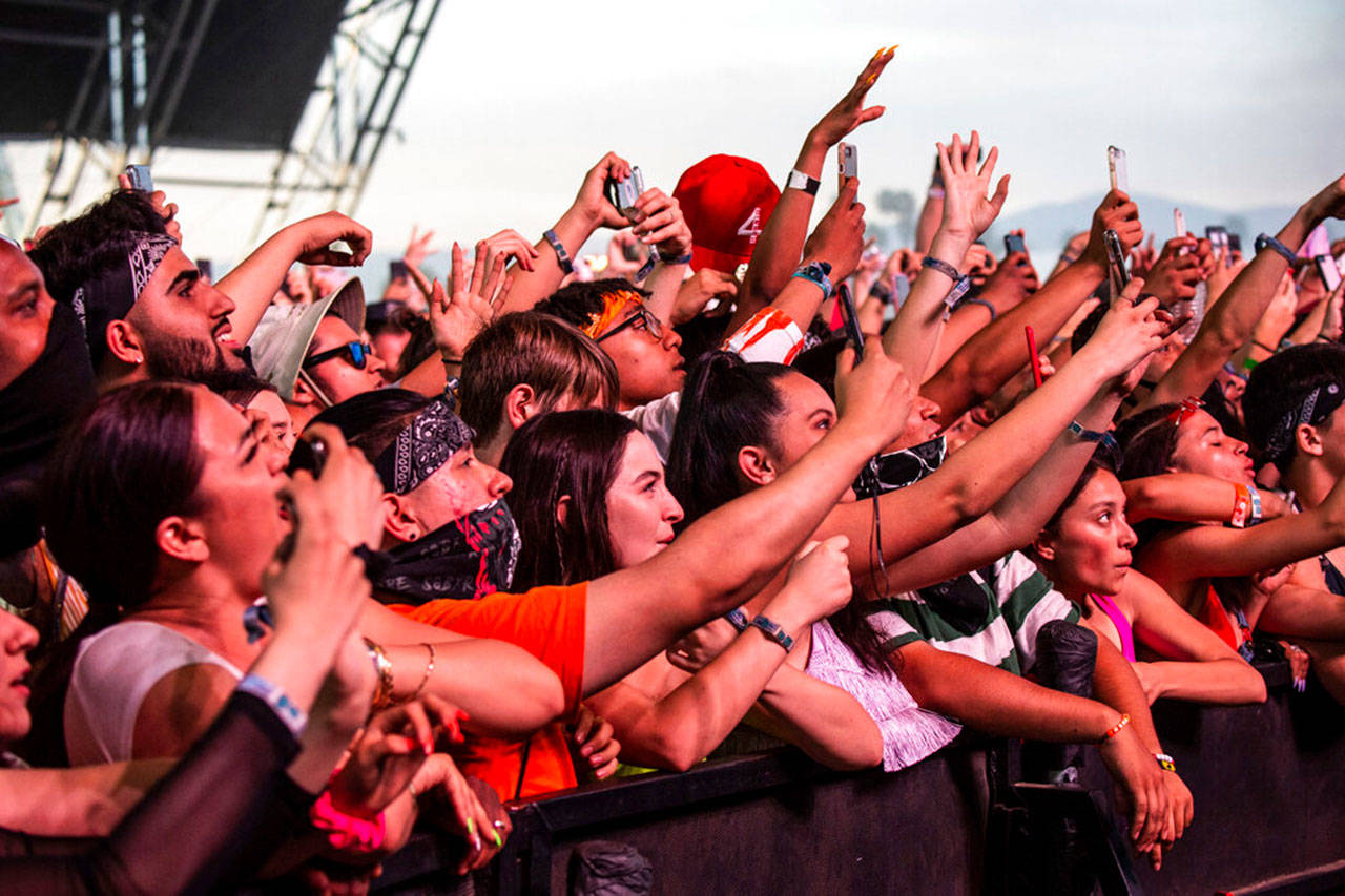 In this April 14, 2019, file photo, festival-goers attend the Coachella Music & Arts Festival at the Empire Polo Club in Indio, Calif. The 2020 Coachella music festival is being postponed from April to October amid concerns about the new coronavirus and large public gatherings. (Photo by Amy Harris/Invision/AP, File)