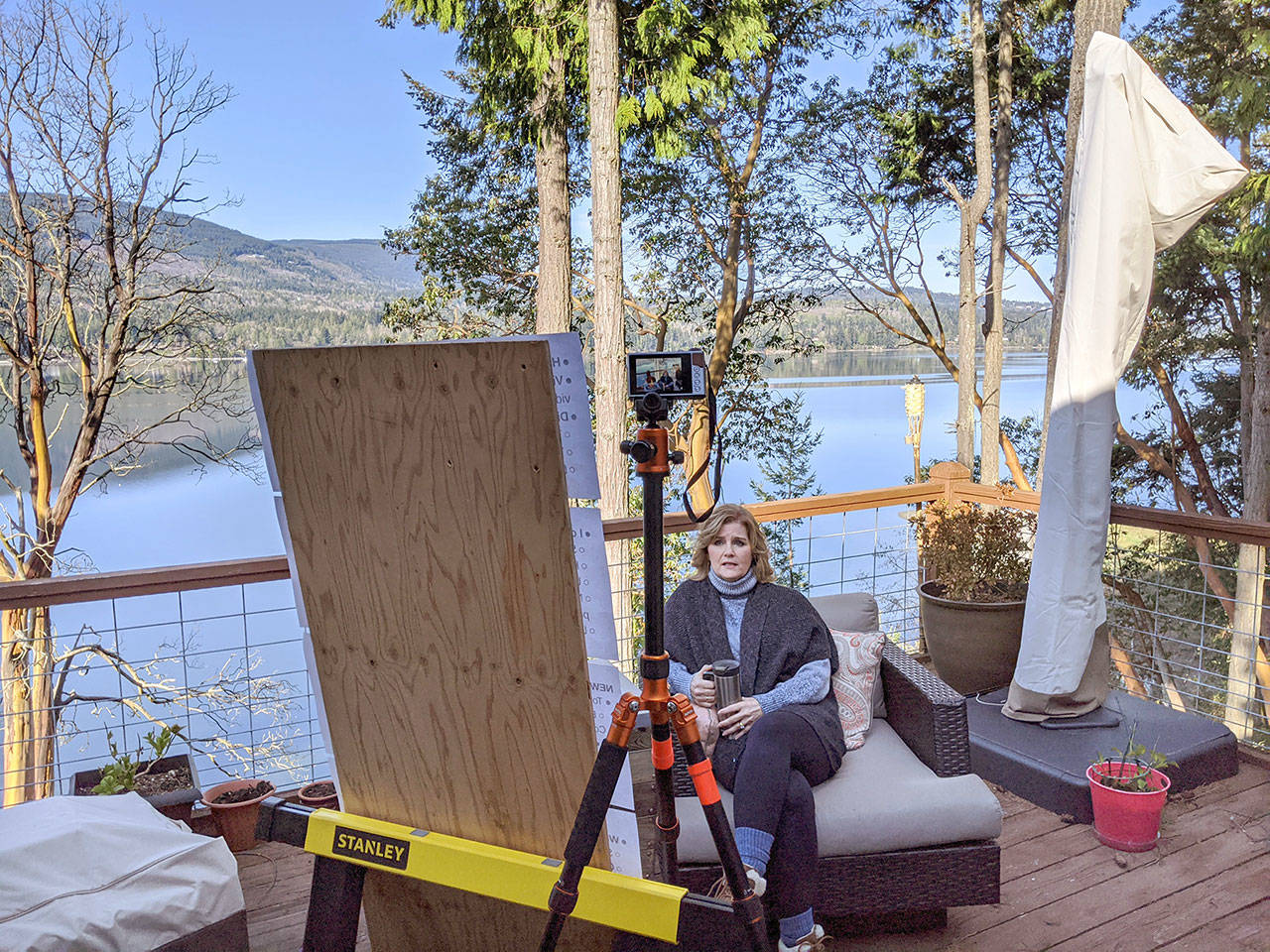 Kimberly Knudson, a first-grade teacher in the Quilcene School District, records lessons and conducts Zoom calls with students on her deck.