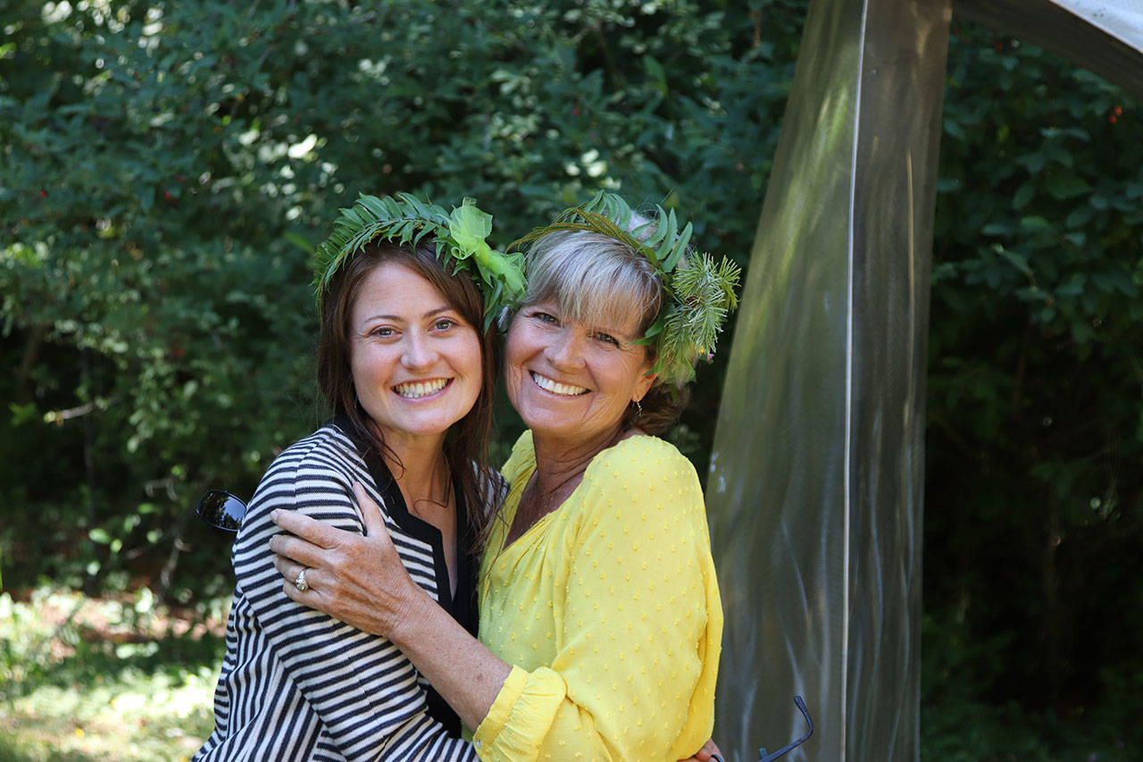 PAFAC Community Outreach Coordinator Lauren Bailey, left, and volunteer Wendy Cutting show off handmade Solstice Crowns at last year’s summer art festival. Photo by Sarah Jane