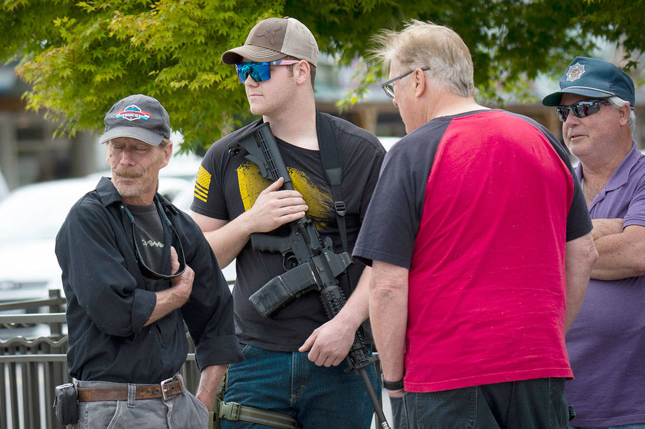 A few men with guns attended the peaceful protest in Sequim on Wednesday. (Jesse Major/For Peninsula Daily News) A few men with guns attended the peaceful protest in Sequim on Wednesday. A protester open carries an AR-15 in downtown Sequim on Wednesday, following a false report that violent protesters had just arrived to Sequim. (Jesse Major/for Peninsula Daily News)