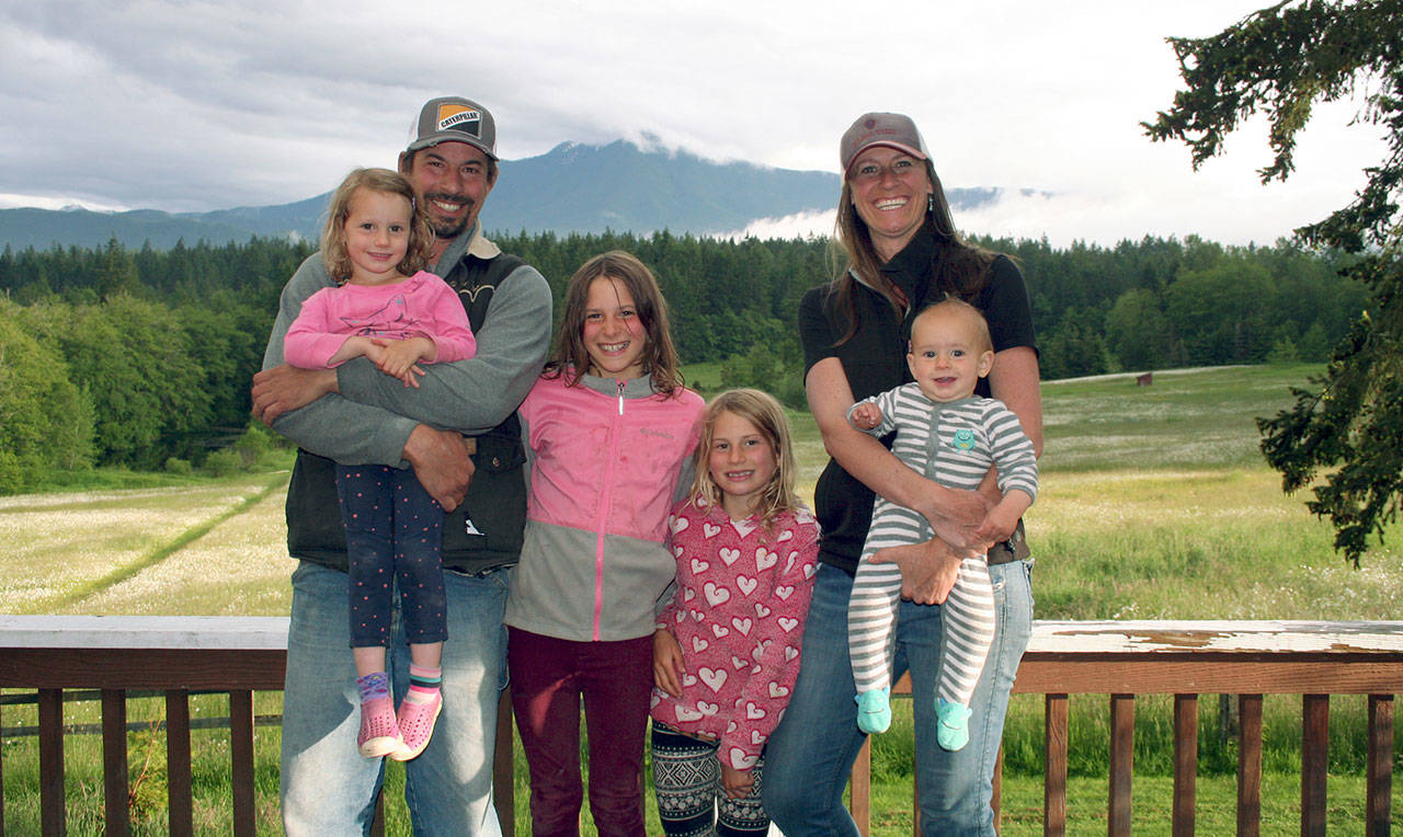 Caring for creatures great and small is a family affair for farrier Pat Par, left, with Emerson, Reegan and Sloan, along with his wife, large animal veterinarian Tara Black, and their youngest creation, Ty. (Karen Griffiths/for Peninsula Daily News)