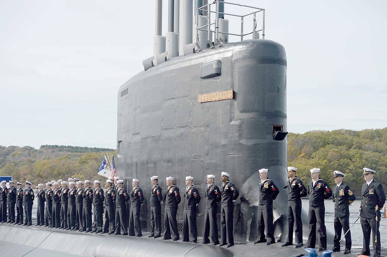 This Oct. 29, 2016, file photo shows the commissioning of the attack submarine USS Illinois as sailors stand atop the sub in Groton, Conn. For decades, the Navy’s leading supplier of high-strength steel for submarines provided subpar metal because one of the company’s longtime employees falsified lab results, putting sailors at greater risk in the event of collisions or other impacts, federal prosecutors said in court filings Monday, June 15, 2020. The supplier, Kansas City-based Bradken Inc., paid $10.9 million as part of a deferred prosecution agreement, the Justice Department said. The company provides steel castings that Navy contractors Electric Boat and Newport News Shipbuilding use to make submarine hulls. The government did not disclose which subs were affected. (Jessica Hill/Associated Press file)
