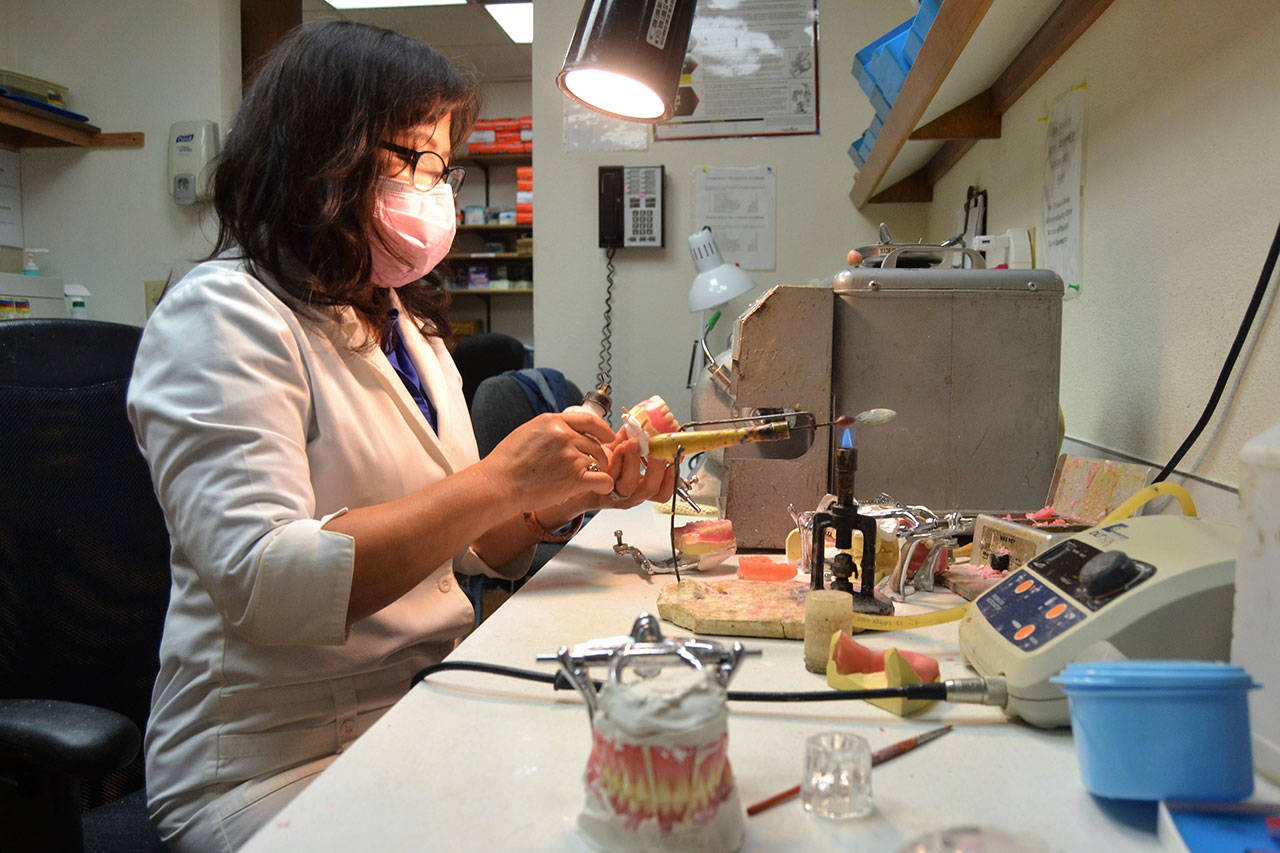 Lien Trinh, owner of DentureCare Inc., prepares some dentures for patients at her West Spruce Street business. She’s one of many Sequim businesses receiving a business grant from the City of Sequim to help during the pandemic. (Matthew Nash/Olympic Peninsula News Group)