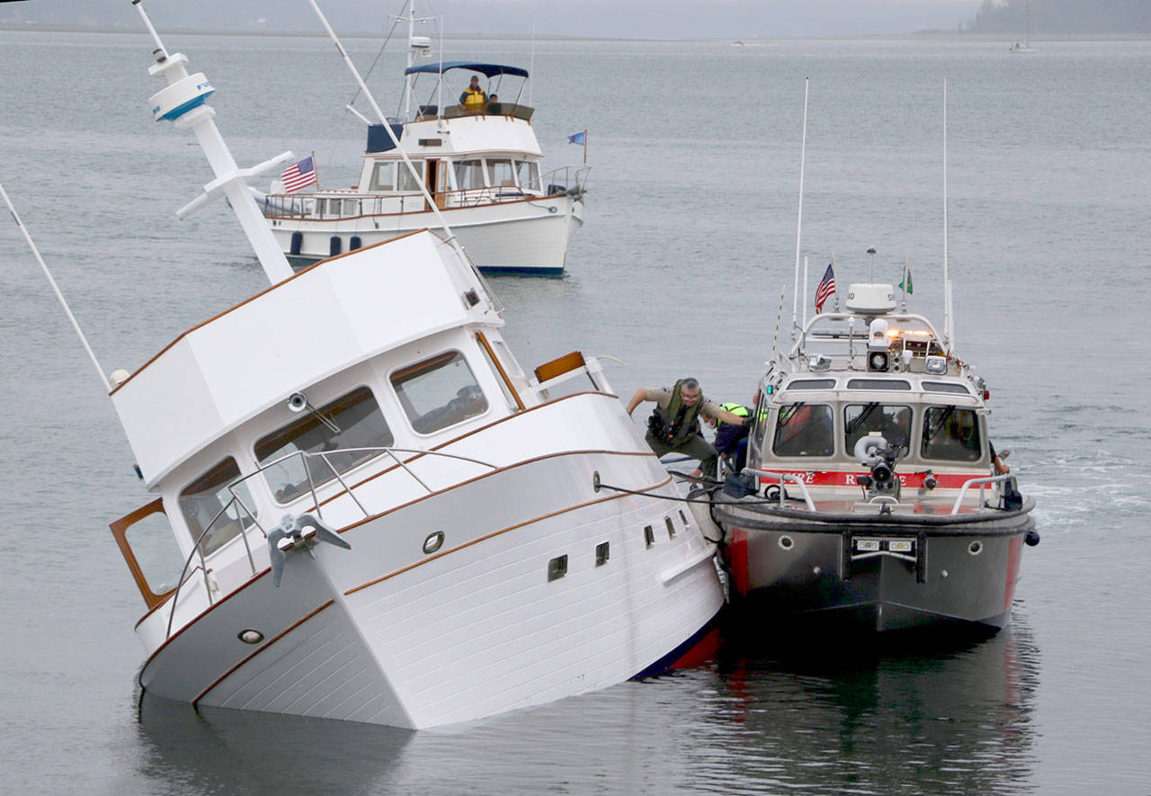 Multiple emergency response agencies responded to a call of a sinking boat off the east side of Point Hudson on Thursday. (Ken Park/Peninsula Daily News)