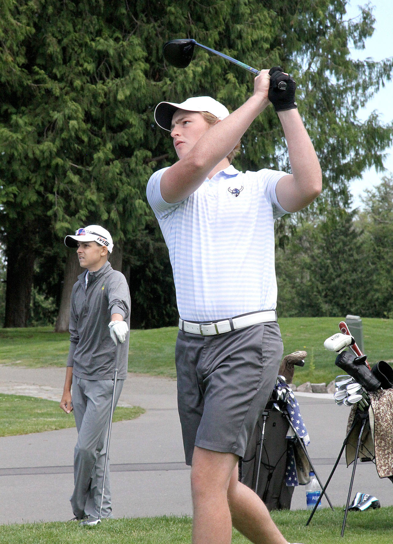 Western Washington University’s Devin Andrews tees off at the first hole at Cedars at Dungeness on Sunday, July 12, 2020, in the Clallam County Amateur. Andrews won the event by two strokes, with second-place finisher Cole Reynolds of Auburn in the background. (Dave Logan/for Peninsula Daily News)