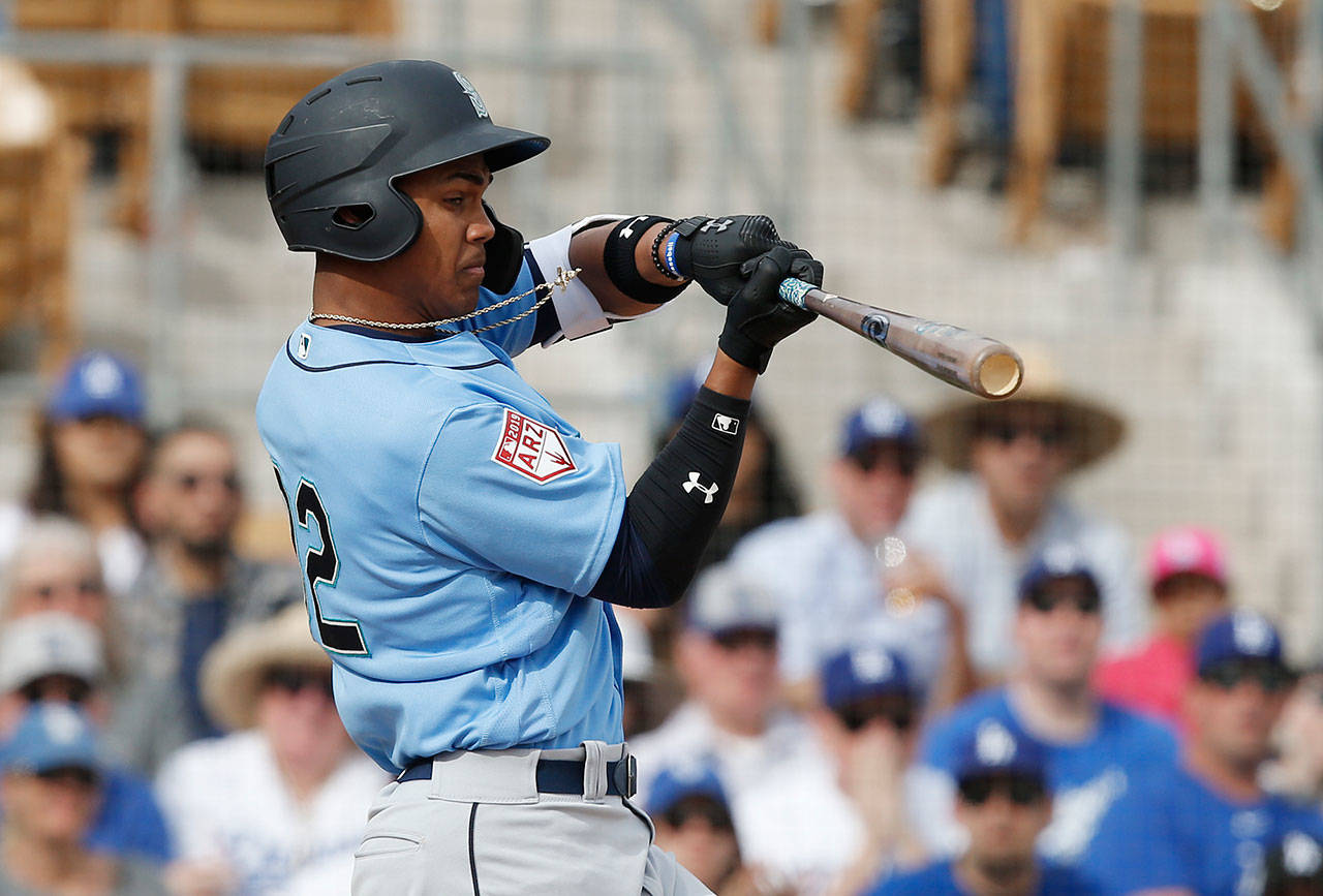 Seattle’s Julio Rodriguez swings during a 2019 spring training contest. Rodriguez, the team’s No. 2 overall prospect, suffered a hairline fracture of his left wrist the team confirmed Thursday. (Sue Ogrocki/Associated Press file)