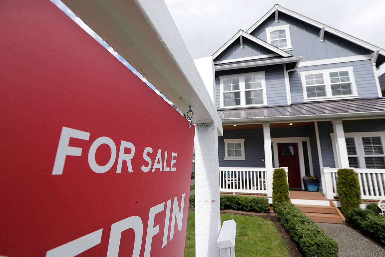 In this April 1, 2020, photo, a “For Sale” sign stands in front of a home that is in the process of being sold in Monroe, Wash., outside of Seattle. Americans stepped up their home purchases in June, clawing back some of the losses after the pandemic had caused sales to crater in the prior three months. (Elaine Thompson/Associated Press file)