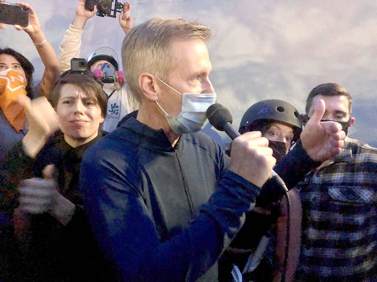 Mayor Ted Wheeler speaks to people gathered in downtown Portland, Ore., Wednesday, July 22, 2020. Wheeler faced a hostile crowd of protesters, who screamed at and sharply questioned him as he tried to rally demonstrators who have clashed repeatedly with federal agents sent in by President Donald Trump to quell ongoing unrest in the city. (Gillian Flaccus/Associated Press)