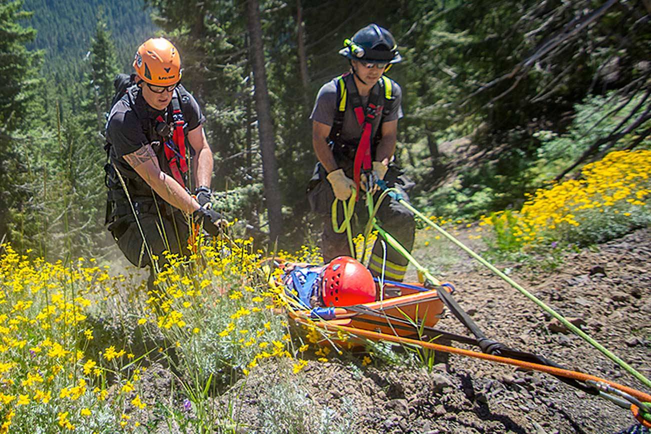 Technical rescue team uses rope system to help woman