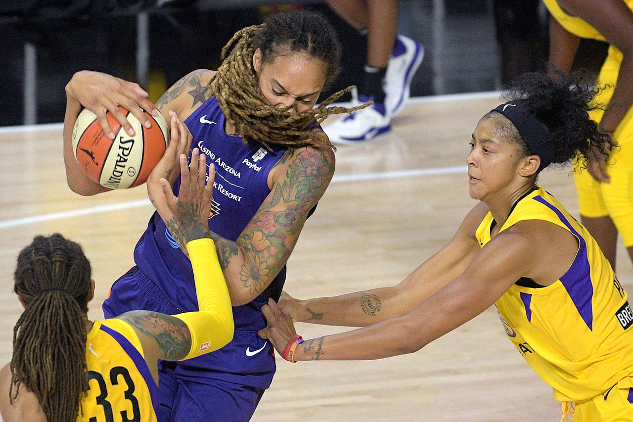 Phoenix Mercury center Brittney Griner, center, fights for position between Los Angeles Sparks center Seimone Augustus (33) and forward Candace Parker, right, during the second half of a WNBA basketball game Saturday, July 25, 2020, in Ellenton, Fla. (Phelan M. Ebenhack/Associated Press)