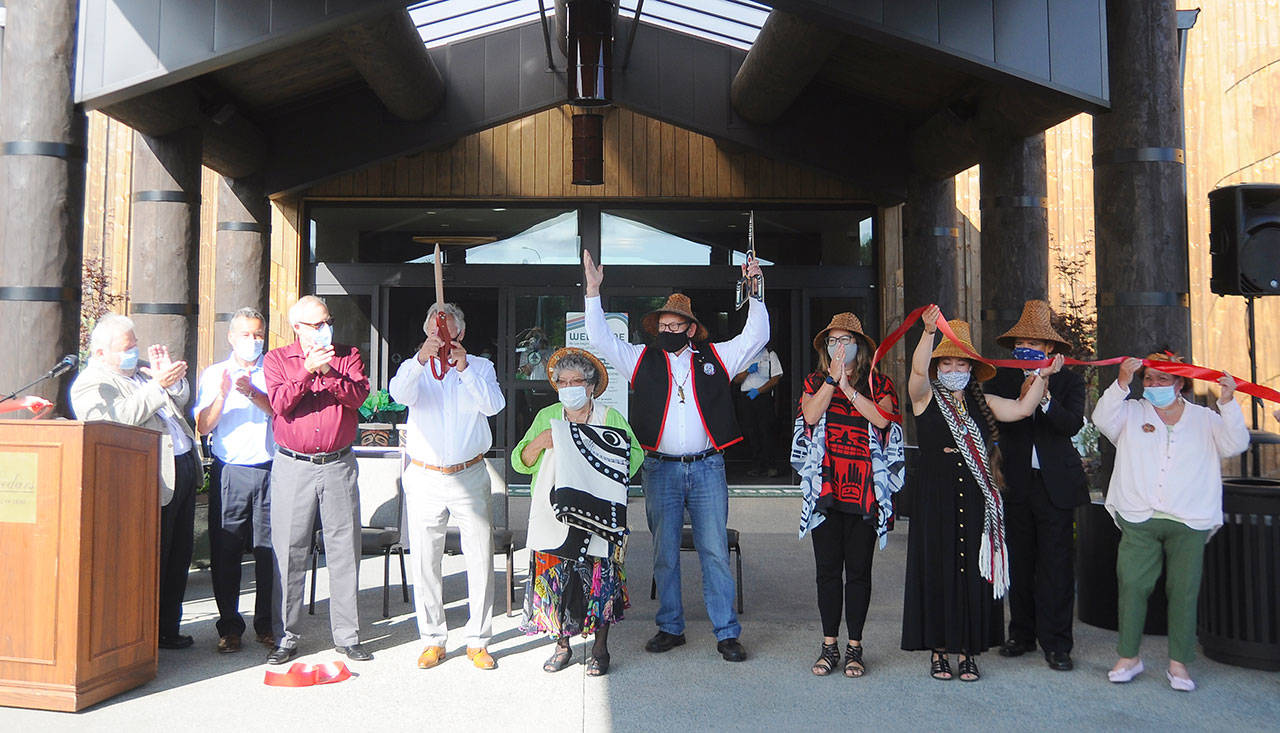 <strong>Michael Dashiell</strong>/Olympic Peninsula News Group                                Helping celebrate the Jamestown S’Klallam Tribe’s opening of the 
7 Cedars Hotel on Tuesday with a ribbon-cutting are, from left Jamestown S’Klallam Tribe Gaming Board council members Cliff Prince, Jim Haugewood and Paul Moore; 7 Cedars Casino CEO Jerry Allen; tribal elder Elaine Grinnell; tribal chairman/CEO W. Ron Allen; and tribal council members Rochelle Blankenship, Loni Greninger, Kurt Grinnell and Theresa Lehman.
