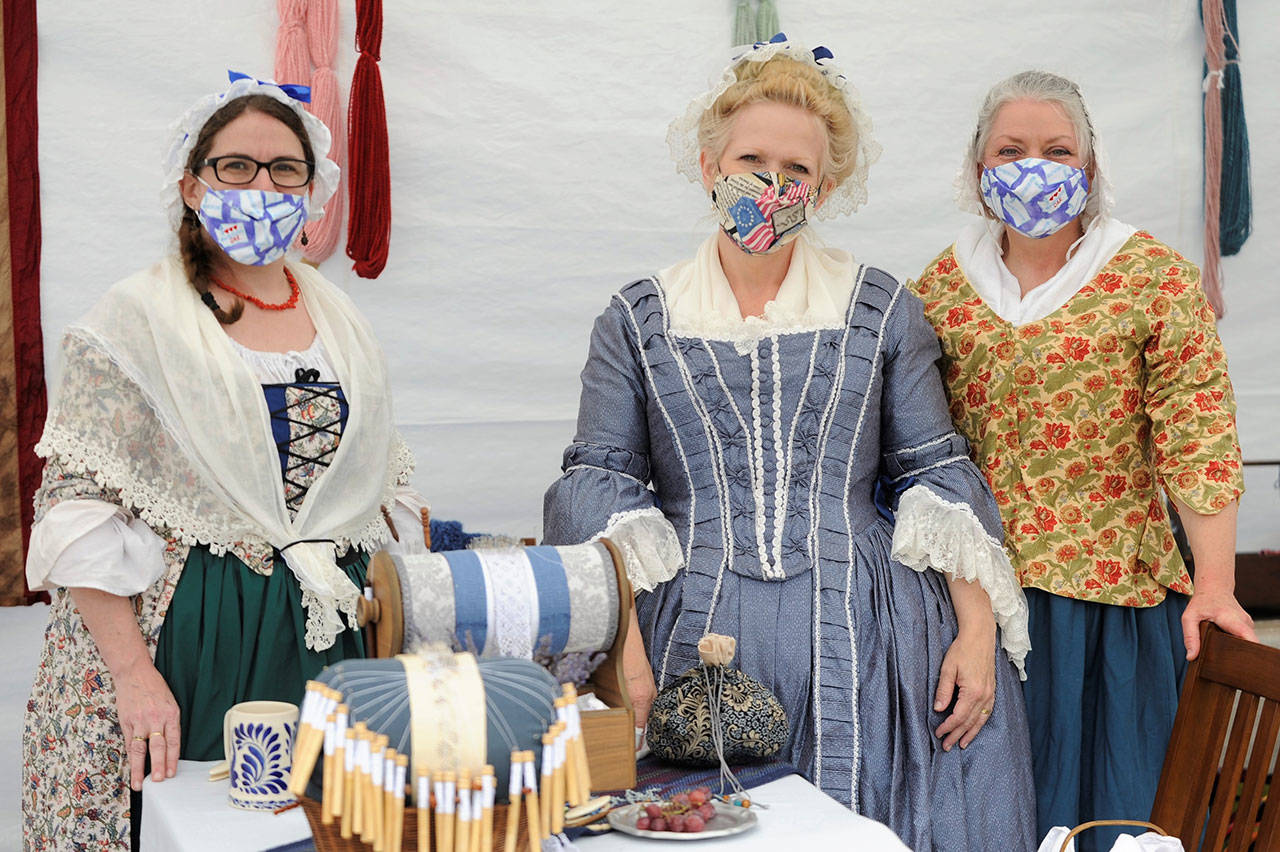 Members of the Mary Ball chapter of the Daughters of the American Revolution, from left, Coral Hileman of Federal Way, Pam Gassman of Tacoma and Lori Gibson of Oakville, enjoy some time together as they discuss garments from the 1770s. (Matthew Nash/Olympic Peninsula News Group)