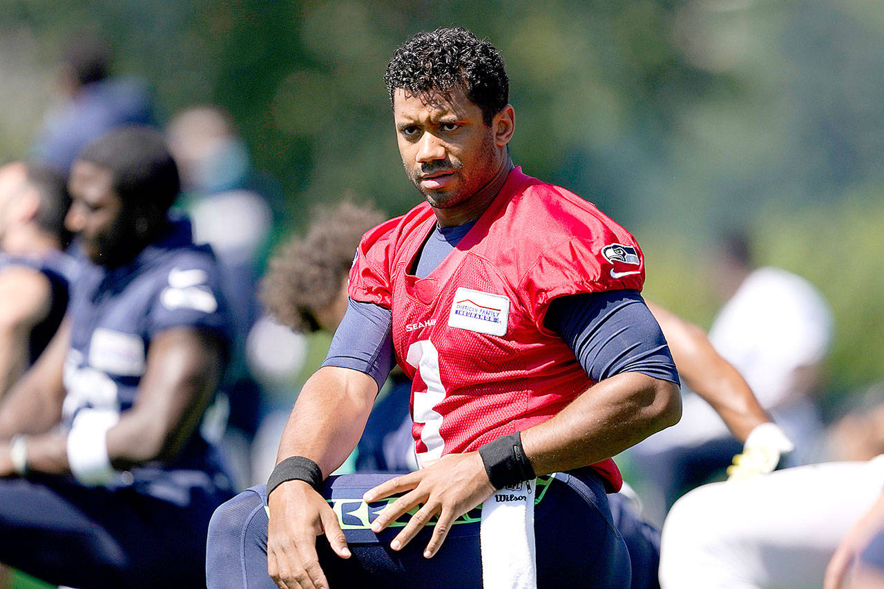 Seattle Seahawks quarterback Russell Wilson stretches before NFL football training camp, Friday, Aug. 14, 2020, in Renton, Wash. (AP Photo/Ted S. Warren)