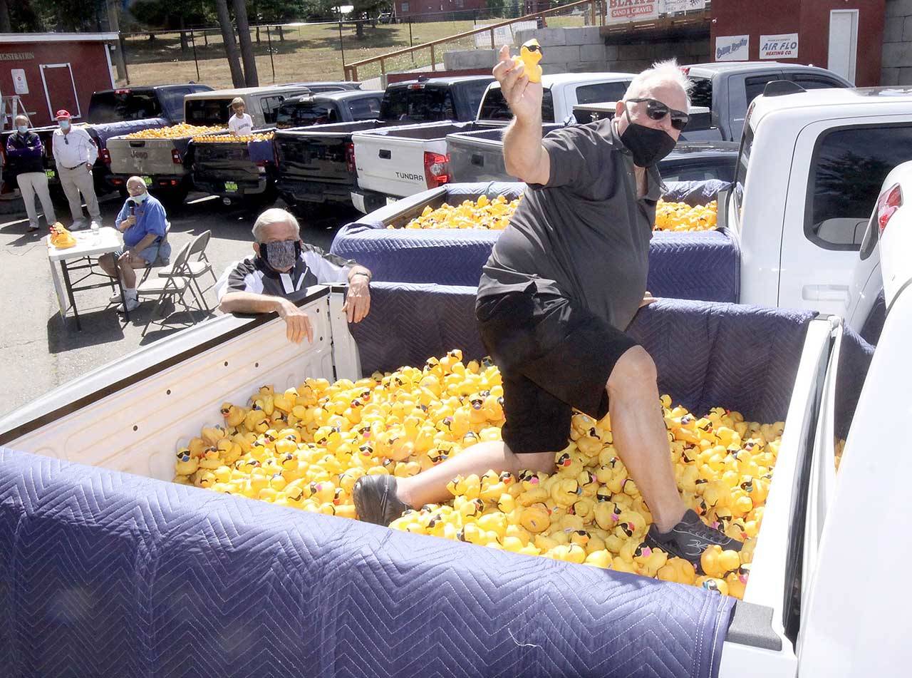 Dan Wilder picks a duck during the 31st annual Great Olympic Peninsula Duck Derby on Sunday at Lincoln Park. (Dave Logan/for Peninsula Daily News)