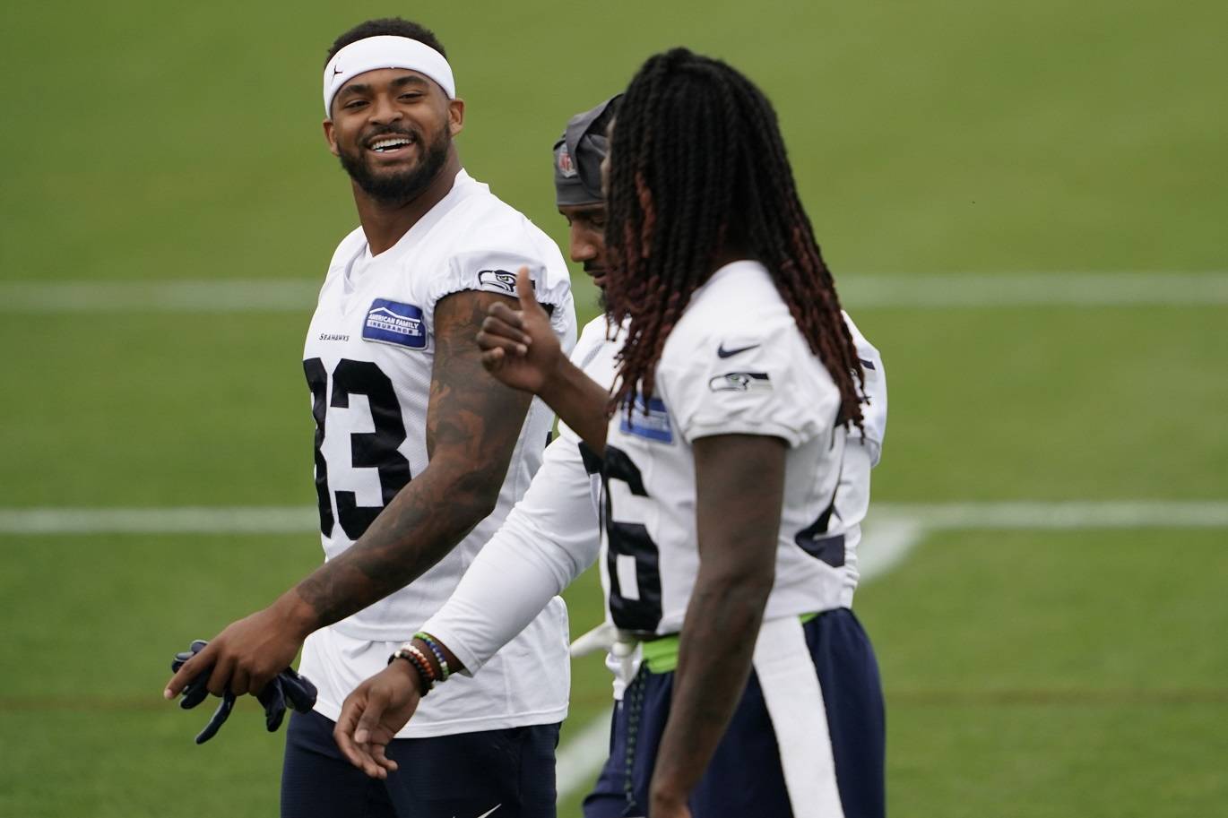 Seattle Seahawks safety Jamal Adams, left, talks with teammates Shaquill Griffin, right, and Quandre Diggs, center during NFL football training camp Aug. 20 in Renton. (Ted S. Warren/The Associated Press)