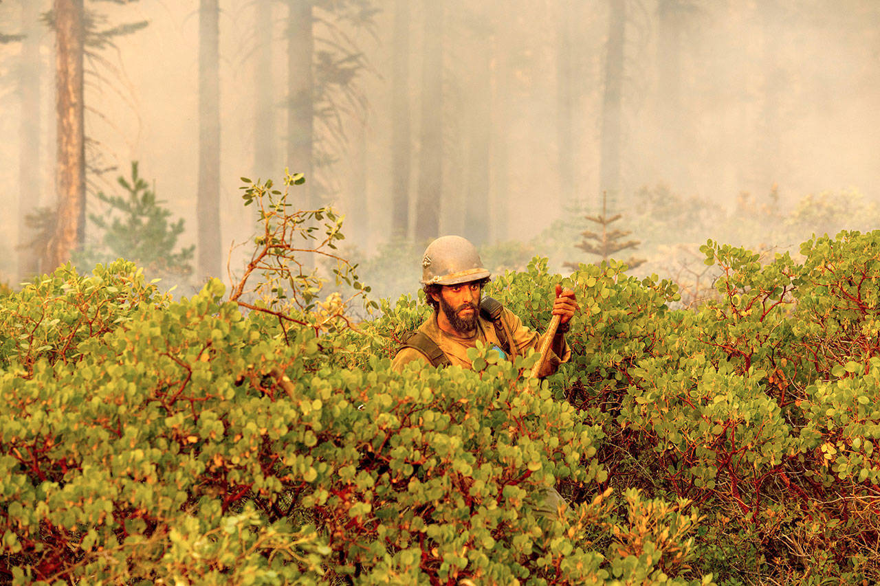 Firefighter Cody Carter battles the North Complex Fire in Plumas National Forest, Calif., on Monday, Sept. 14, 2020. (Noah Berger/Associated Press)
