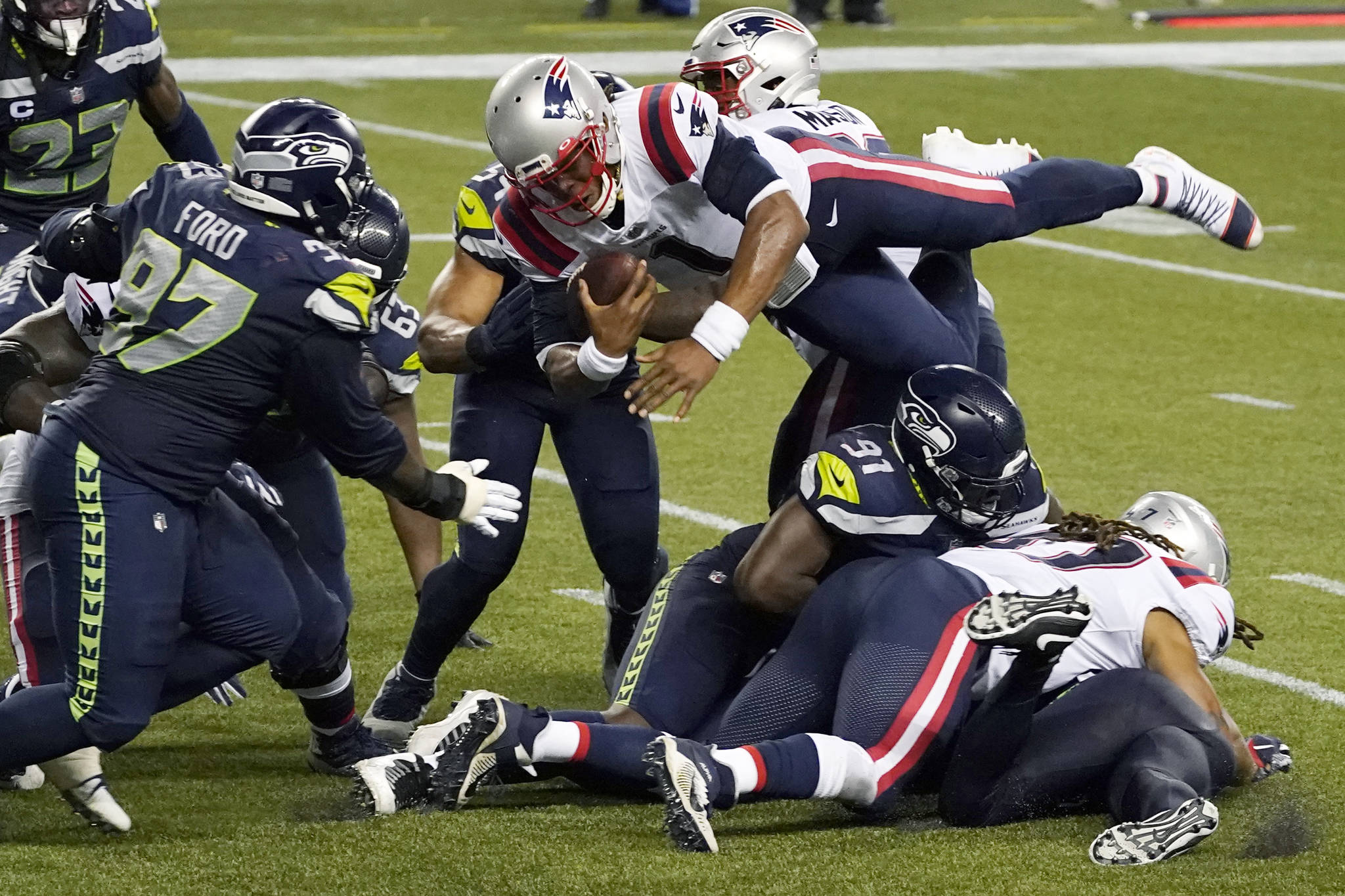 New England Patriots quarterback Cam Newton dives with the ball but is stopped near the goal line as the clock expires in the fourth quarter against the Seattle Seahawks Sunda in Seattle. The Seahawks won 35-30. (AP Photo/Elaine Thompson)