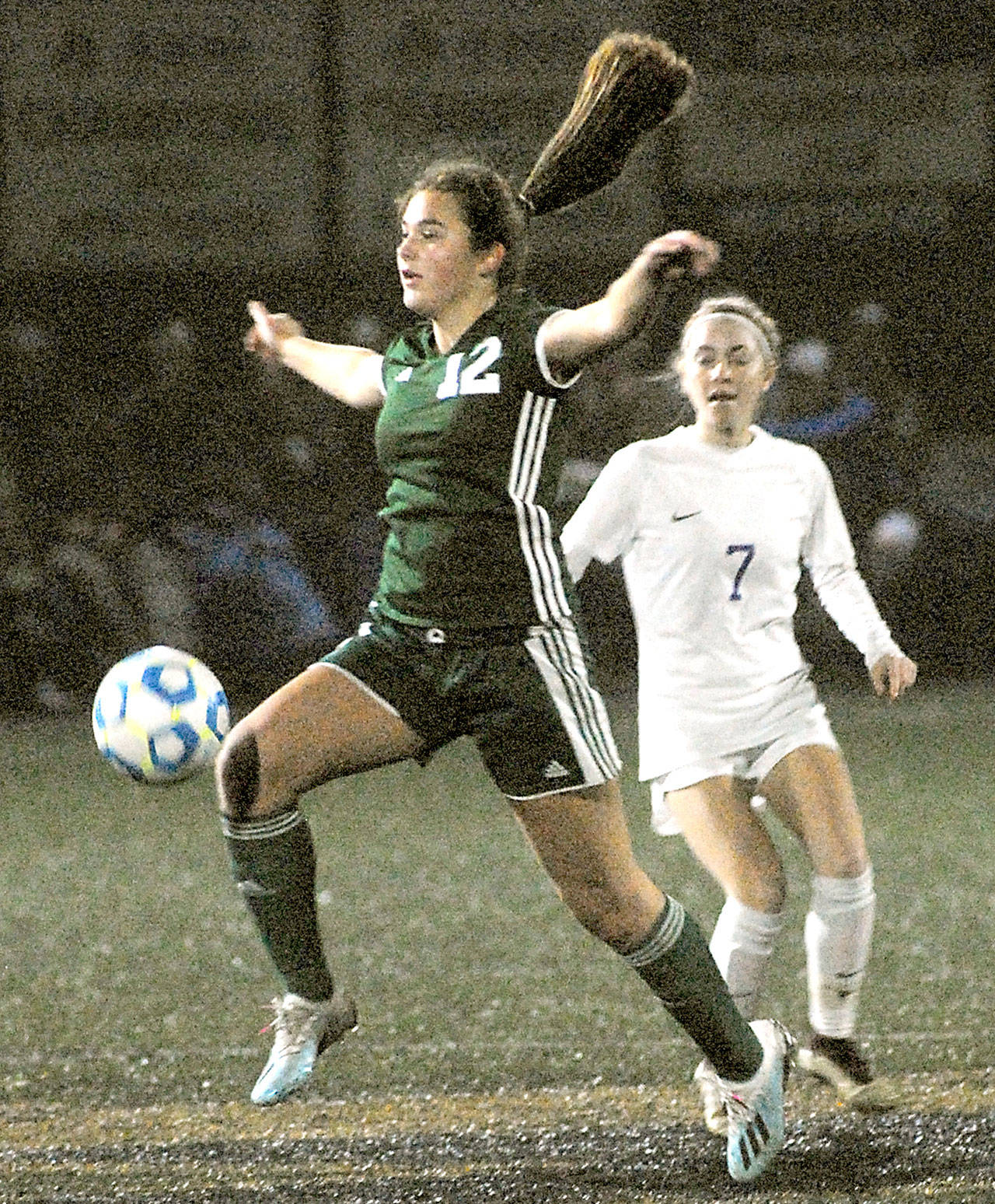Port Angeles’ Eve Burke controls the ball in front of Sequim’s Daisy Ryan during a district playoff game at Peninsula College in November 2019. (Keith Thorpe/Peninsula Daily News file)