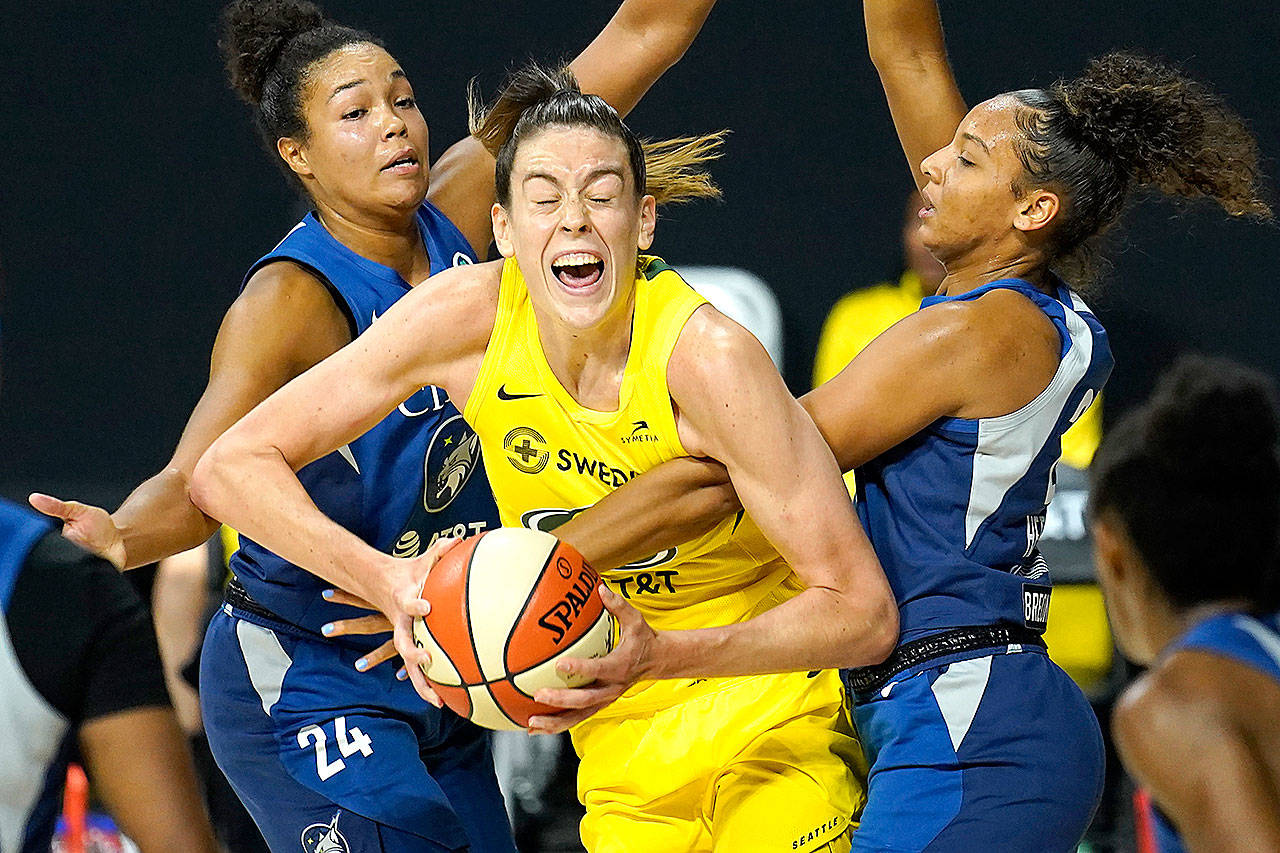 Seattle Storm forward Breanna Stewart (30) gets fouled by Minnesota Lynx forward Mikiah Herbert Harrigan (21) during the second half of Game 3 of a WNBA basketball semifinal round playoff series Sunday in Bradenton, Fla. Looking on is Lynx forward Napheesa Collier (24). (AP Photo/Chris O’Meara)