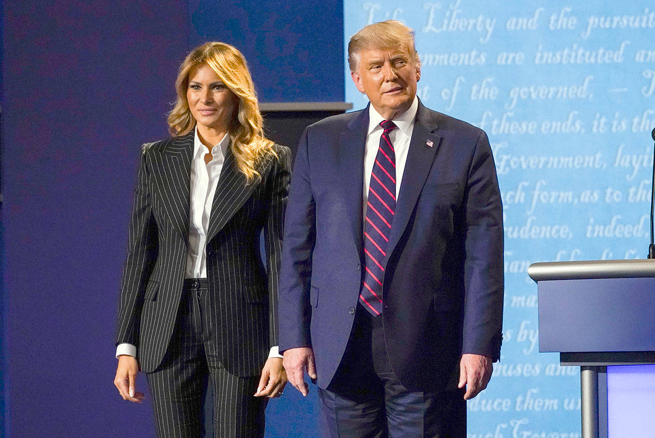 President Donald Trump stands on stage with first lady Melania Trump after the first presidential debate with Democratic presidential candidate former Vice President Joe Biden on Tuesday at Case Western University and Cleveland Clinic in Cleveland, Ohio. (Julio Cortez/Associated Press)