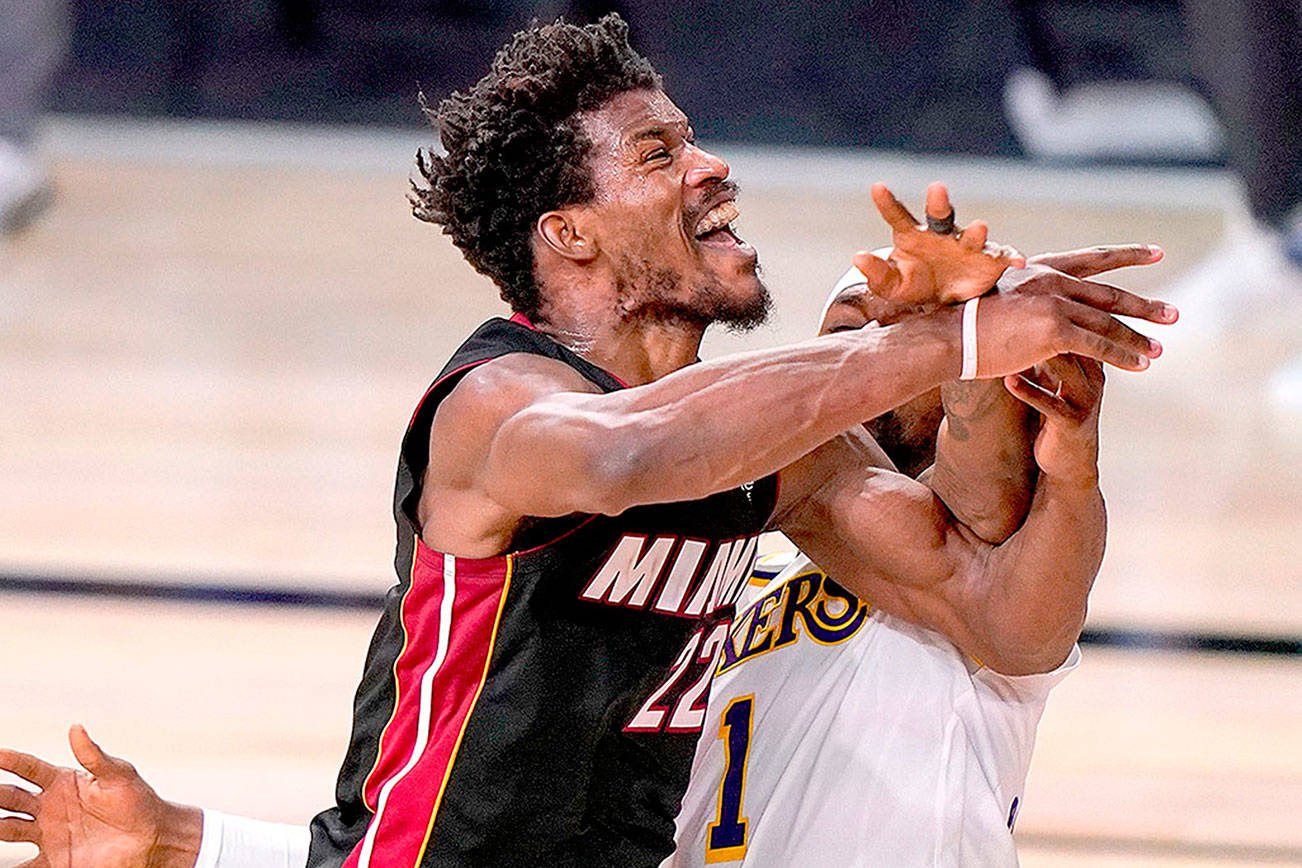 Miami Heat’s Jimmy Butler (22) is fouled Sunday by Los Angeles Lakers’ Kentavious Caldwell-Pope (1) during Game 3 of the NBA Finals in Lake Buena Vista, Fla. (AP Photo/Mark J. Terrill)