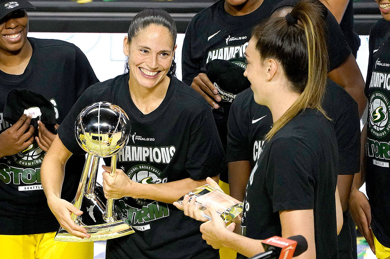 Seattle Storm guard Sue Bird, left, smiles at Breanna Stewart after the team defeated the Las Vegas Aces to win basketball’s WNBA championship Tuesday, Oct. 6, 2020, in Bradenton, Fla. (Chris O’Meara/Associated Press)