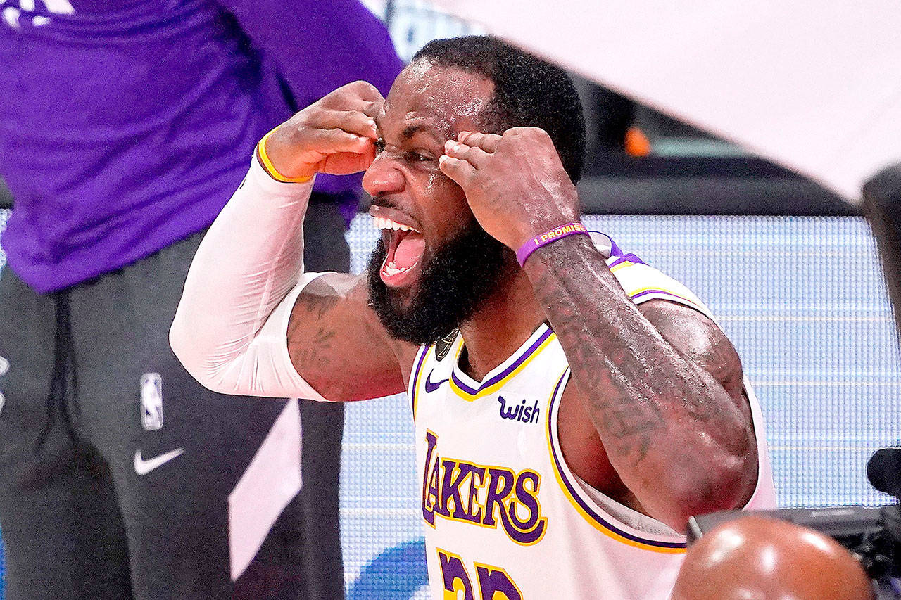 Los Angeles Lakers' LeBron James (23) celebrates after the Lakers defeated the Miami Heat 106-93 in Game 6 of basketball's NBA Finals Sunday, Oct. 11, 2020, in Lake Buena Vista, Fla. (AP Photo/Mark J. Terrill)