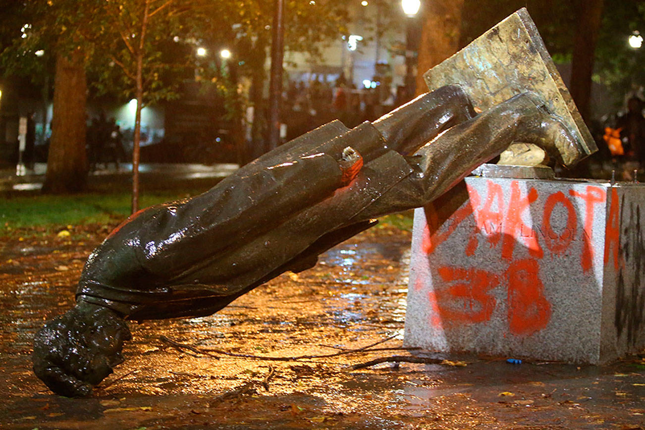 A group of protesters toppled statues of former presidents Theodore Roosevelt and Abraham Lincoln in Portland's South Park Block late Sunday, Oct. 11, 2020. (Sean Meagher/The Oregonian via AP)