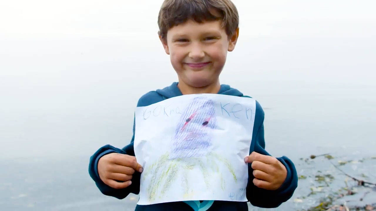 Jefferson County first-grader Henry Norris shows off his winning drawing in Gov. Jay Inslee’s contest to find and draw a kraken in the Salish Sea. Inslee announced the contest the day the new Seattle NHL hockey franchise introducted its Kraken nickname. (Seattle Kraken)