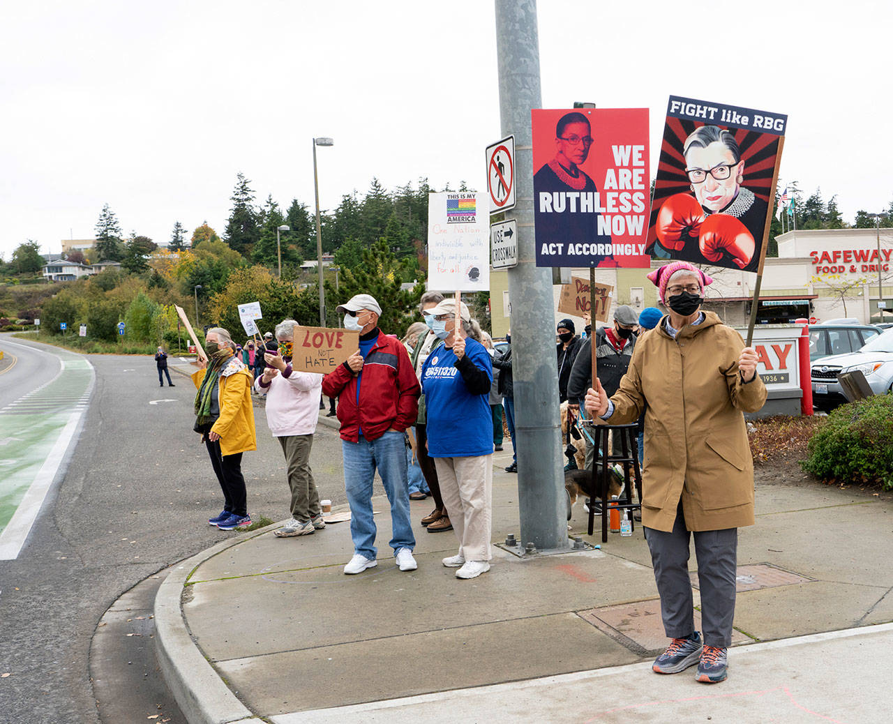 Karen Sturnick of Port Townsend holds signs she had made to honor the legacy of former Supreme Court justice Ruth Bader Ginsburg, who died on Sept. 18 at the age of 87 after serving 27 years on the court. The rally on Saturday took over the four corners of Sims Way and Haines Place with 60 or more voicing their support for the late justice and her rulings. (Steve Mullensky/for Peninsula Daily News)