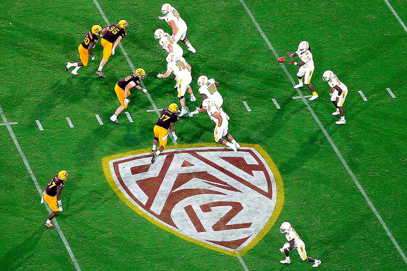 FILE - In this Aug. 29, 2019, file photo, is the Pac-12 logo during the second half of an NCAA college football game between Arizona State and Kent State, in Tempe, Ariz. The return of football isn't likely to make much of a dent in the losses athletic departments across the Pac-12 will ultimately incur because of the coronavirus pandemic. Faced with dramatic budget shortfalls, most schools in the league have already resorted to layoffs, furloughs, and cutting some sports entirely. (AP Photo/Ralph Freso, File)