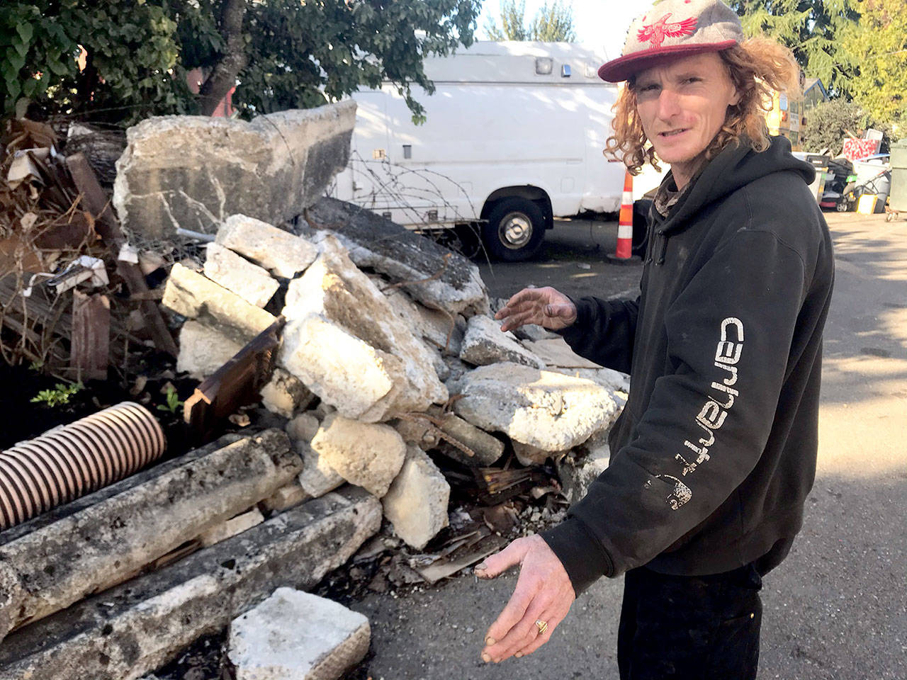 Cody Coughenour was continuing his cleanup Tuesday, Oct. 20, 2020, of three properties on East Fifth Street. (Paul Gottlieb/Peninsula Daily News)