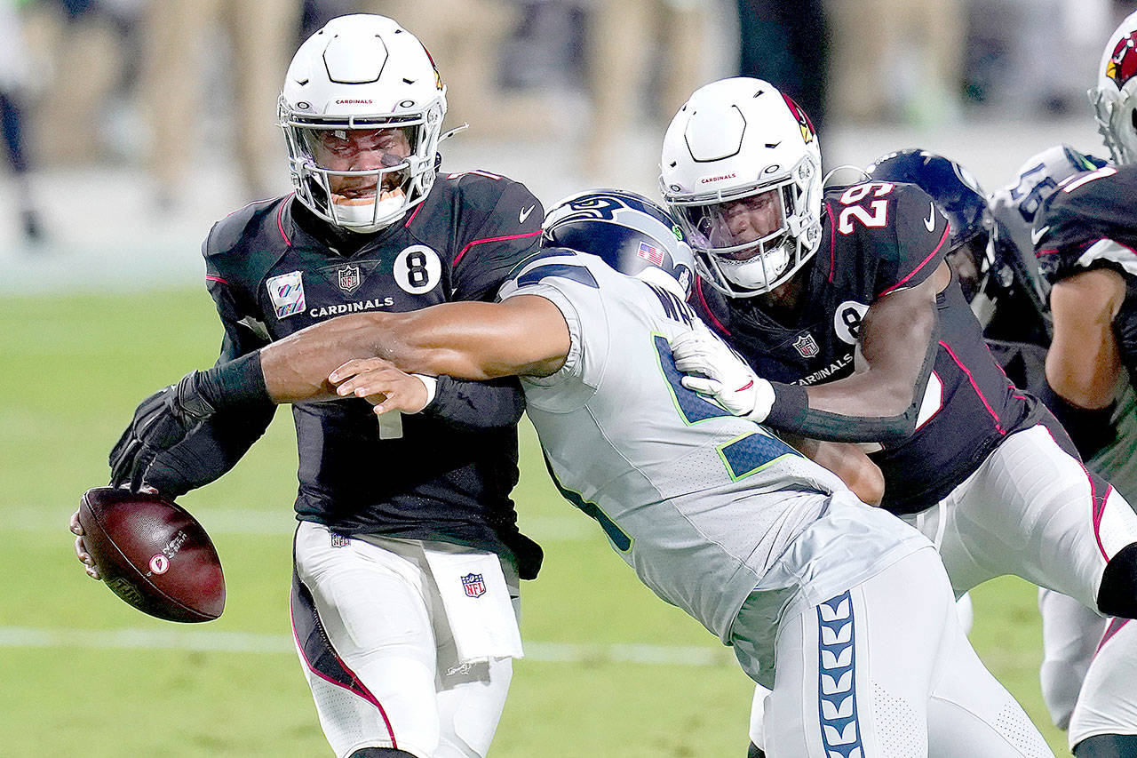 Arizona Cardinals quarterback Kyler Murray avoids the sack as Seattle Seahawks middle linebacker Bobby Wagner, right, makes the hit during the first half of an NFL football game Sunday, Oct. 25, 2020, in Glendale, Ariz. (Ross D. Franklin/Associated Press)