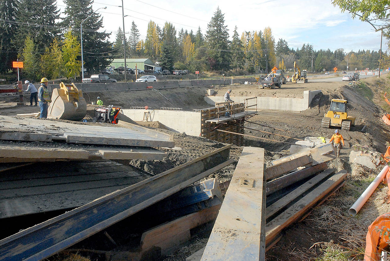 Crews work to replace the north portion of a set of culverts under U.S. Highway 101 at Bagley Creek east of Port Angeles. (Keith Thorpe/Peninsula Daily News)