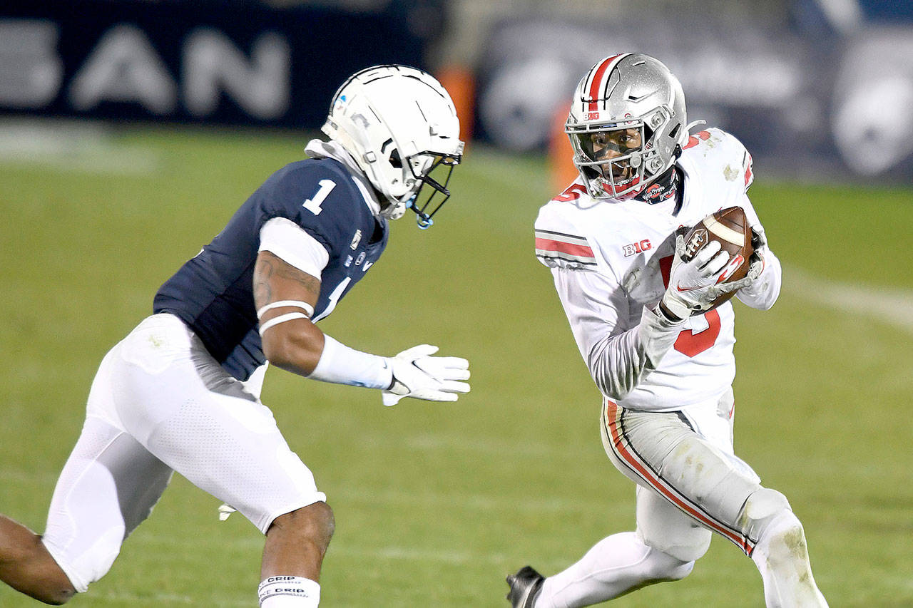 Ohio State wide receiver Garrett Wilson (5) catches a pass in front of Penn State safety Jaquan Brisker (1) during the fourth quarter in State College, Pa., Saturday.Ohio State won 38-25. (AP Photo/Barry Reeger)