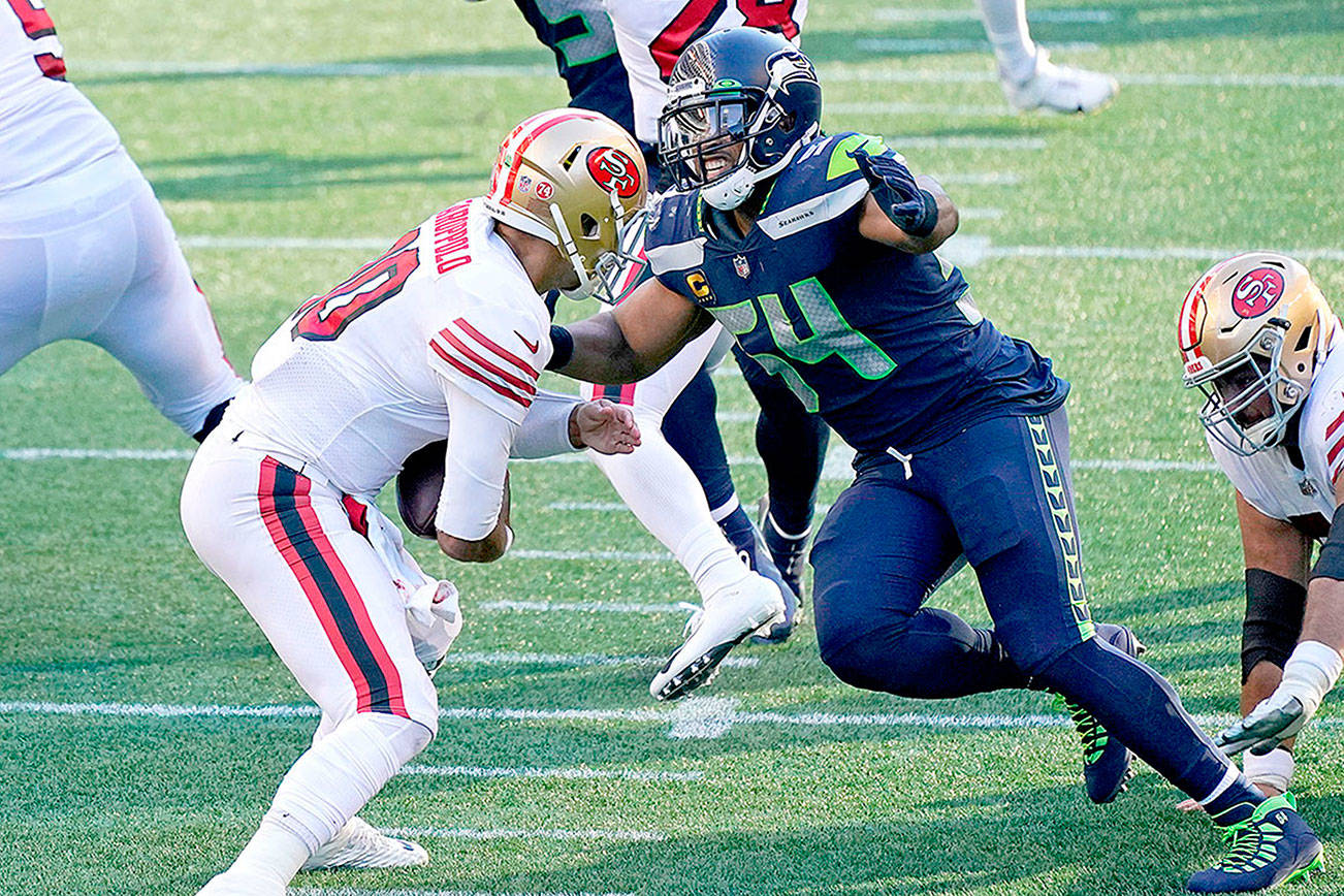 Seattle Seahawks middle linebacker Bobby Wagner, right, sacks San Francisco 49ers quarterback Jimmy Garoppolo during the first half of an NFL football game, Sunday, Nov. 1, 2020, in Seattle. (AP Photo/Elaine Thompson)