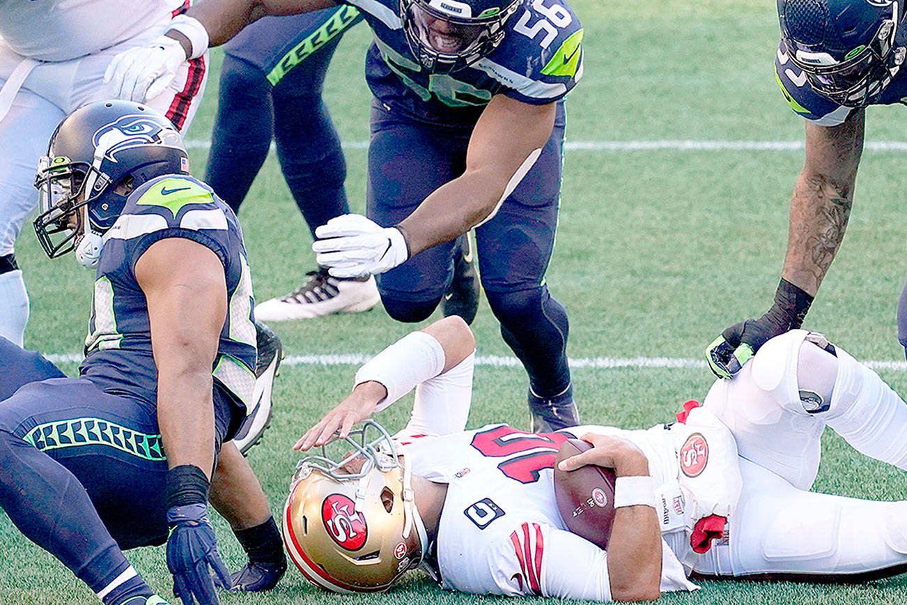San Francisco 49ers quarterback Jimmy Garoppolo reacts after he was sacked by Seattle Seahawks middle linebacker Bobby Wagner during the first half of an NFL football game, Sunday, Nov. 1, 2020, in Seattle. (AP Photo/Elaine Thompson)