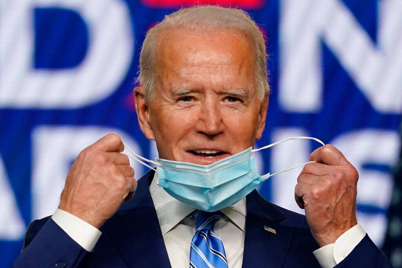 Democratic presidential candidate former Vice President Joe Biden takes off his face mask as he arrives to speak Wednesday, Nov. 4, 2020, in Wilmington, Del. (Carolyn Kaster/Associated Press)