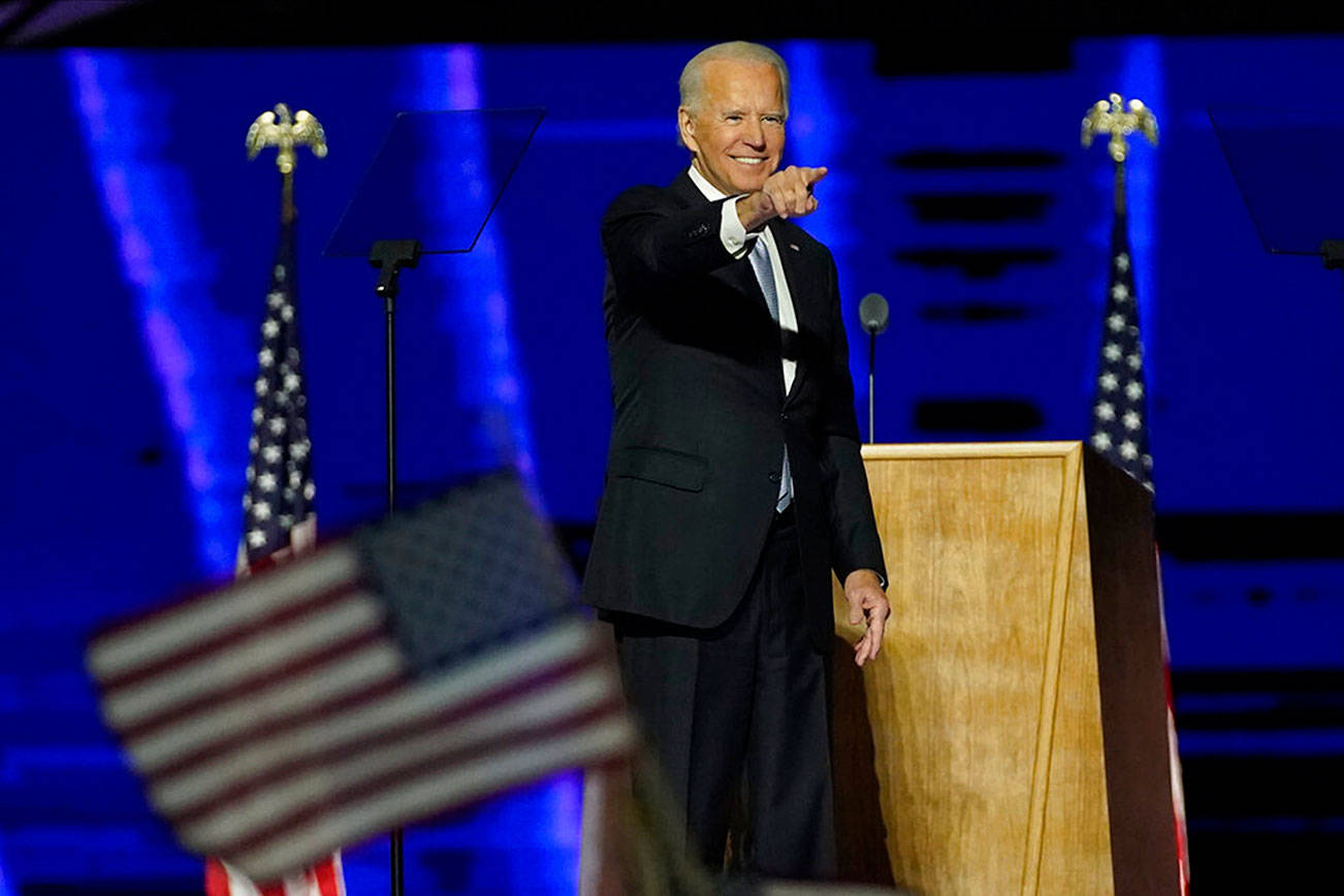 President-elect Joe Biden gestures on stage after speaking, Saturday, Nov. 7, 2020, in Wilmington, Del. (AP Photo/Andrew Harnik, Pool)