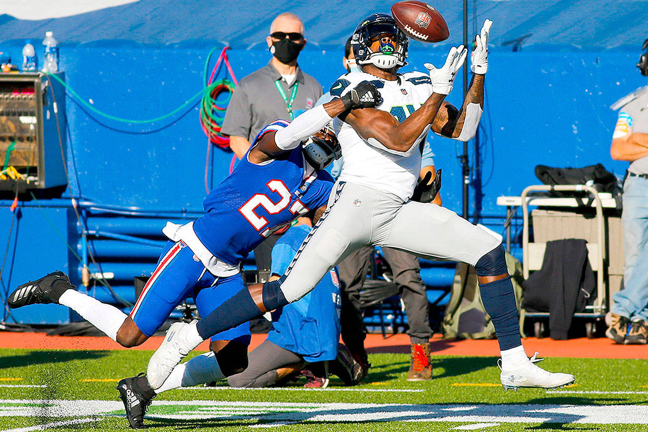 Seattle Seahawks' DK Metcalf (14) catches a pass in front of Buffalo Bills' Tre'Davious White (27) during the first half of an NFL football game Sunday, Nov. 8, 2020, in Orchard Park, N.Y. (AP Photo/Jeffrey T. Barnes)