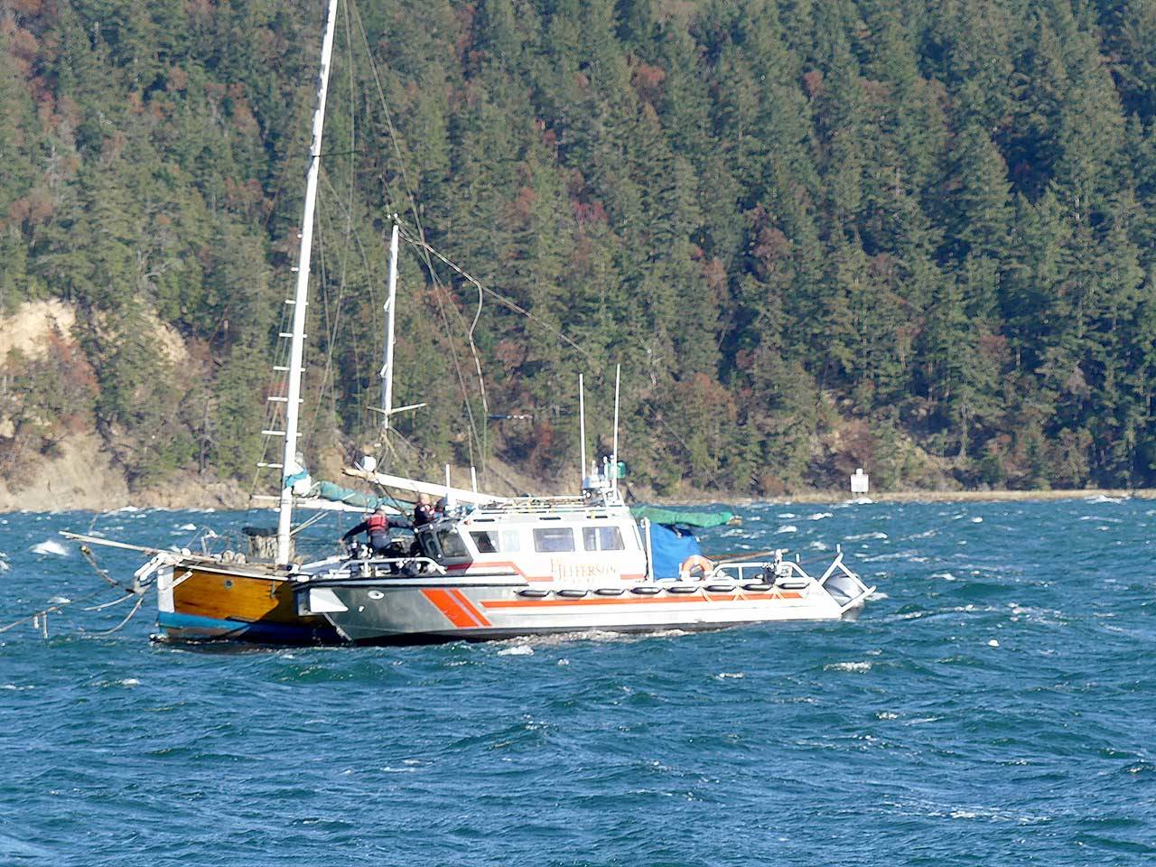 East Jefferson Fire Rescue personnel reach a man and his dog aboard a sailboat after the vessel’s mast broke Sunday. Nov. 8, 2020. (Photo courtesy of East Jefferson Fire Rescue)