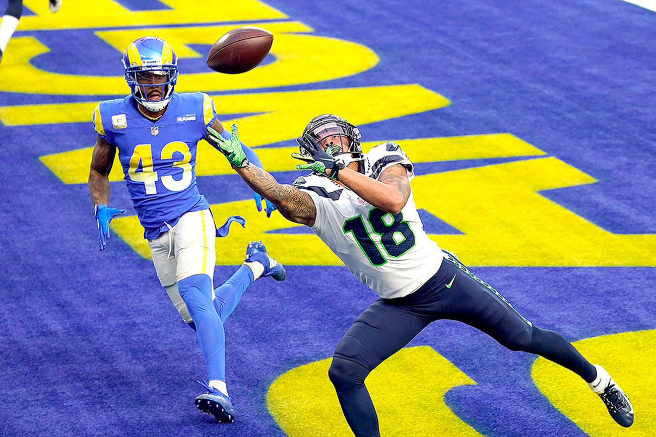Seattle Seahawks wide receiver Freddie Swain (18) reaches but can't catch a pass in the end zone during the first half of an NFL football game against the Los Angeles Rams Sunday, Nov. 15, 2020, in Inglewood, Calif. (AP Photo/Ashley Landis)