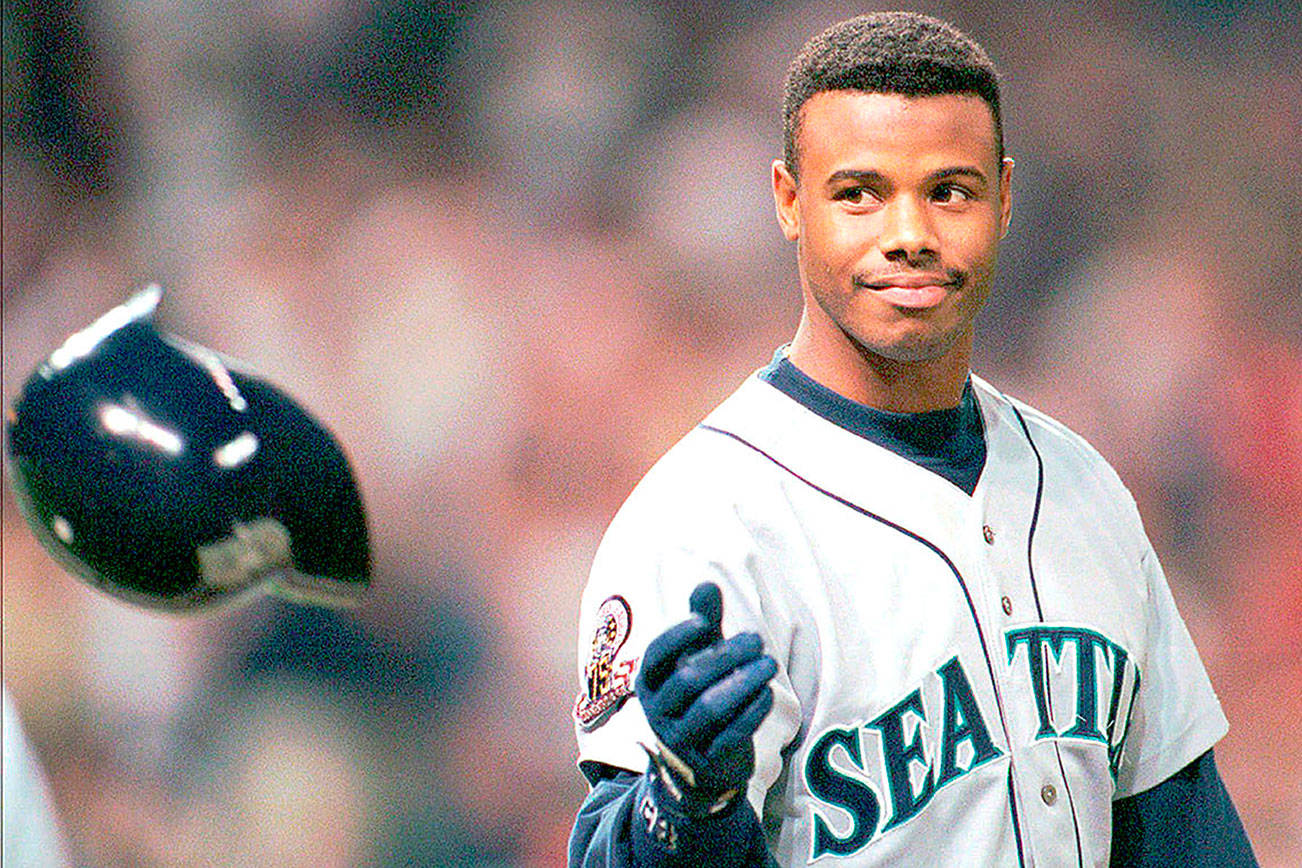 FILE - In this Oct. 13, 1995, file photo, Seattle Mariners Ken Griffey Jr. tosses his batting helmet after grounding out in the eighth inning against the Cleveland Indians in an ALCS game in Cleveland. The Seattle Mariners are the only baseball franchise never to advance to the Fall Classic. Baseball has never been played in Seattle beyond Oct. 22. The Mariners have three times been to the American League Championship Series, and all three times were sent home before there could ever be a Game 7. (AP Photo/Mark Duncan, File)