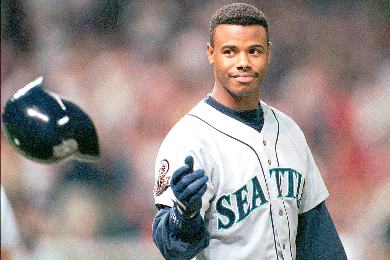 In this Oct. 13, 1995, file photo, Seattle Mariners Ken Griffey Jr. tosses his batting helmet after grounding out in the eighth inning against the Cleveland Indians in an ALCS game in Cleveland. Griffey Jr. just joined the ownership group of the Seattle Sounders. (AP Photo/Mark Duncan, File)