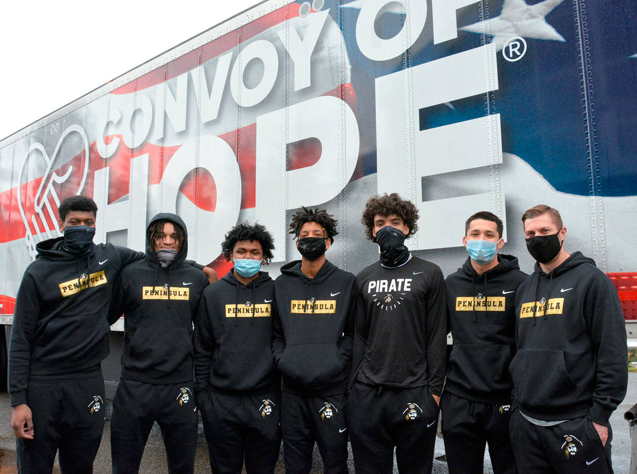 Peninsula College men’s basketball players recently assisted Port Angeles’ Lighthouse Christian Center and Convoy of Hope volunteers and staff in setting up non-perishable grocery items for distribution to the community. Pirate players are from left, Isaiah Sampson, Jaylin Reed, Lewis Welsh, Mikey Medlock, KeAndre Hunter-Holliday, Neal Garcia and Coach Donald Rollman.