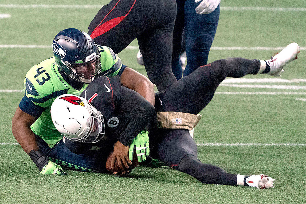 Seattle Seahawks defensive end Carlos Dunlap II sacksl Arizona Cardinals quarterback Kyler Murray on fourth down late in the second half an NFL football game, Thursday, Nov. 19, 2020, in Seattle. The Seahawks won 28-21. (AP Photo/Stephen Brashear)