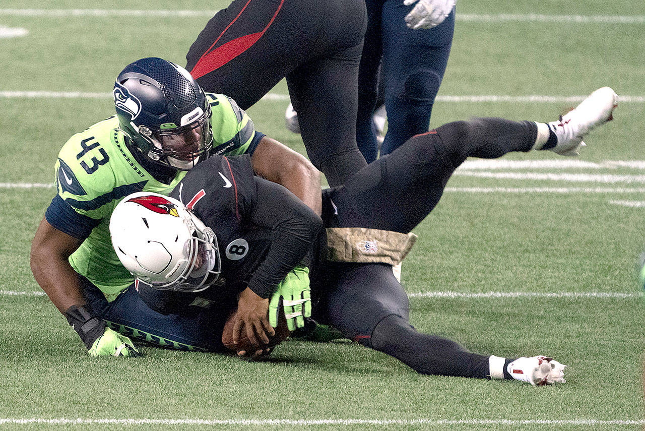 Seattle Seahawks defensive end Carlos Dunlap II sacksl Arizona Cardinals quarterback Kyler Murray on fourth down late in the second half an NFL football game, Thursday in Seattle. The Seahawks won 28-21. (Stephen Brashear/The Associated Press)