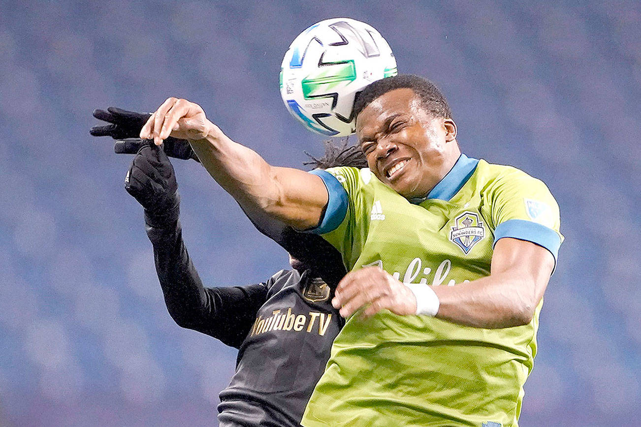 Seattle Sounders defender Nouhou, right, and Los Angeles FC forward Latif Blessing leap to head the ball ball during the second half of an MLS playoff soccer match Tuesday in Seattle. The Sounders won 3-1. (AP Photo/Ted S. Warren)